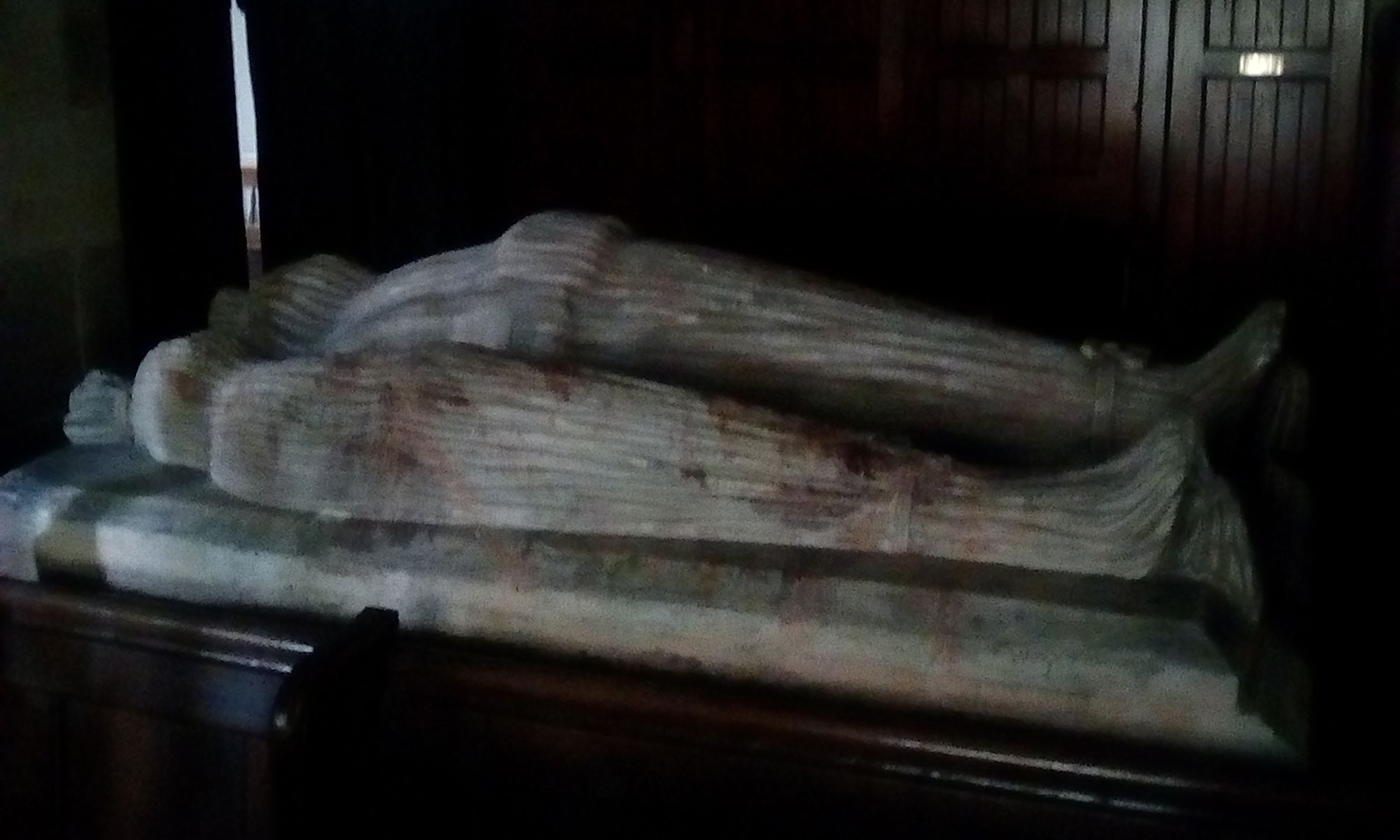 Alabaster tomb of Thomas and Agnes Beresford..shrouded from head to foot.. their 16 sons and five daughters are represented by miniature figures around the tomb base.. all shrouded as well