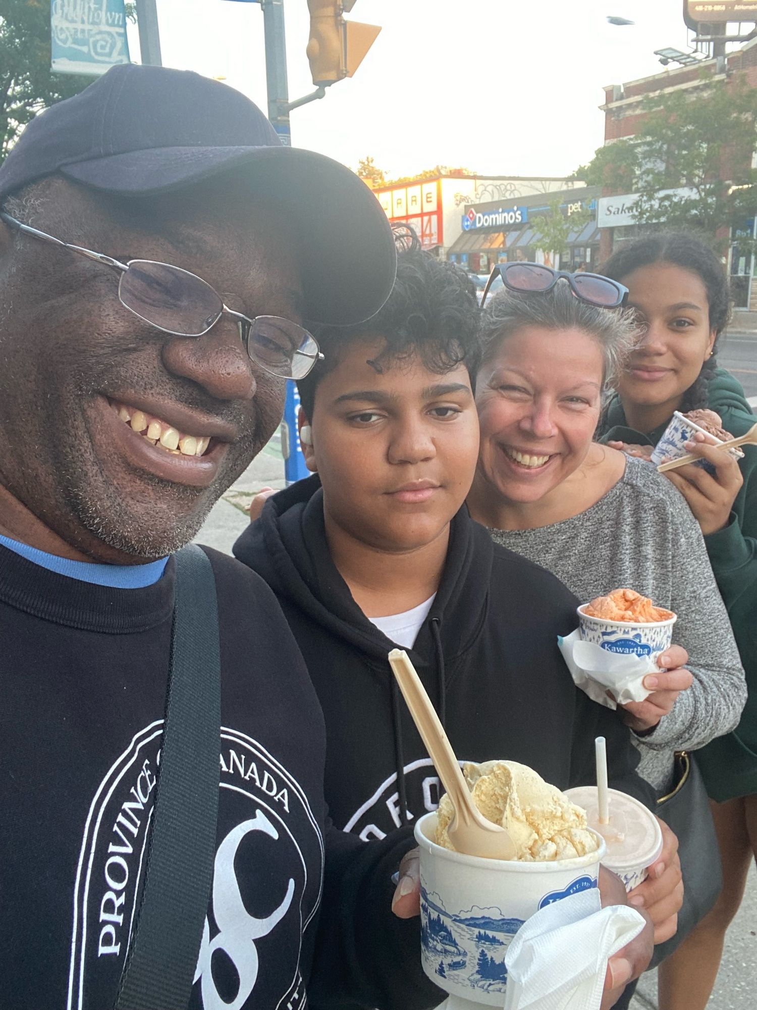 Multiple people outside with ice cream in a cup