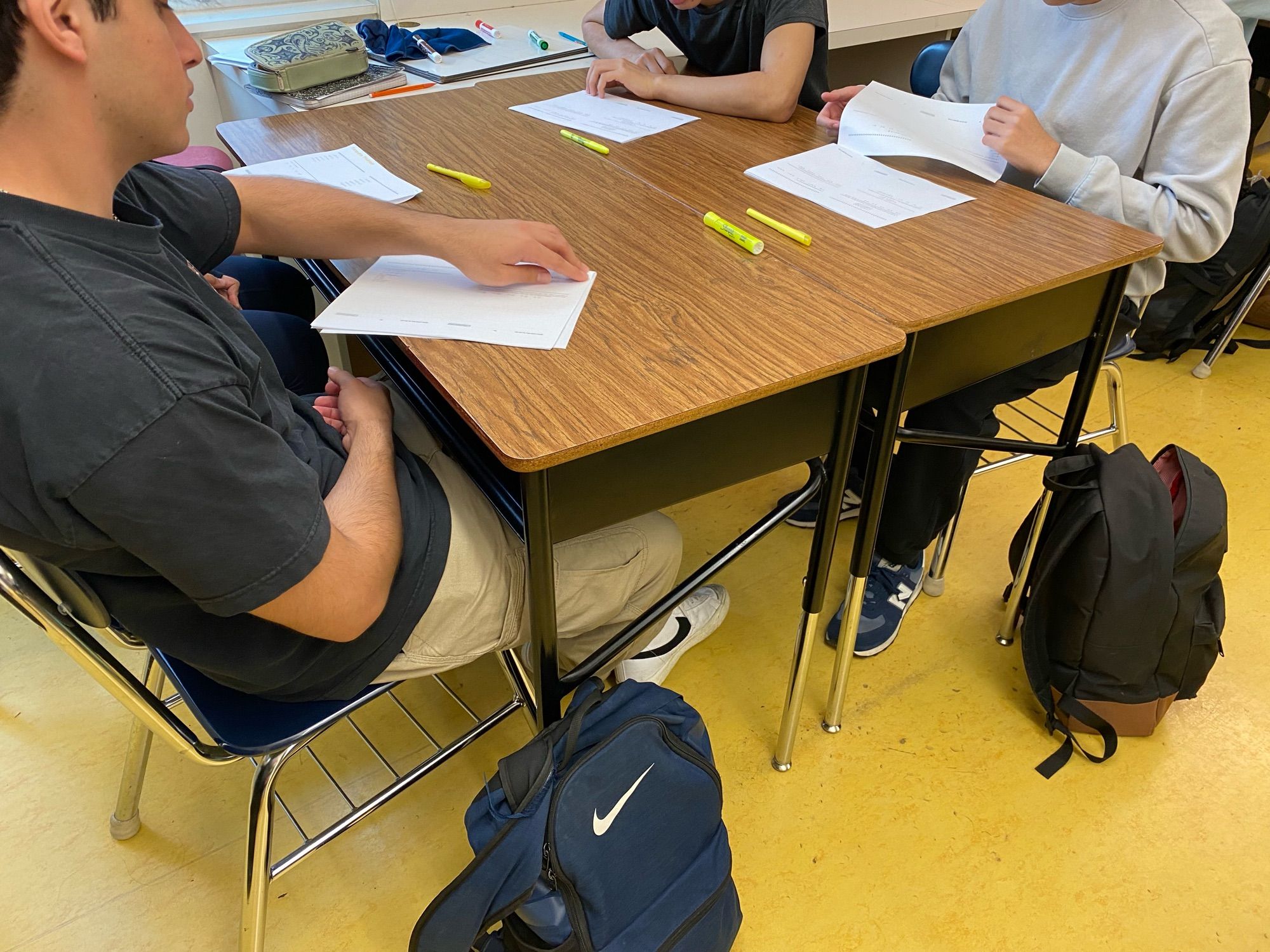 Students at a table discussing test without writing.