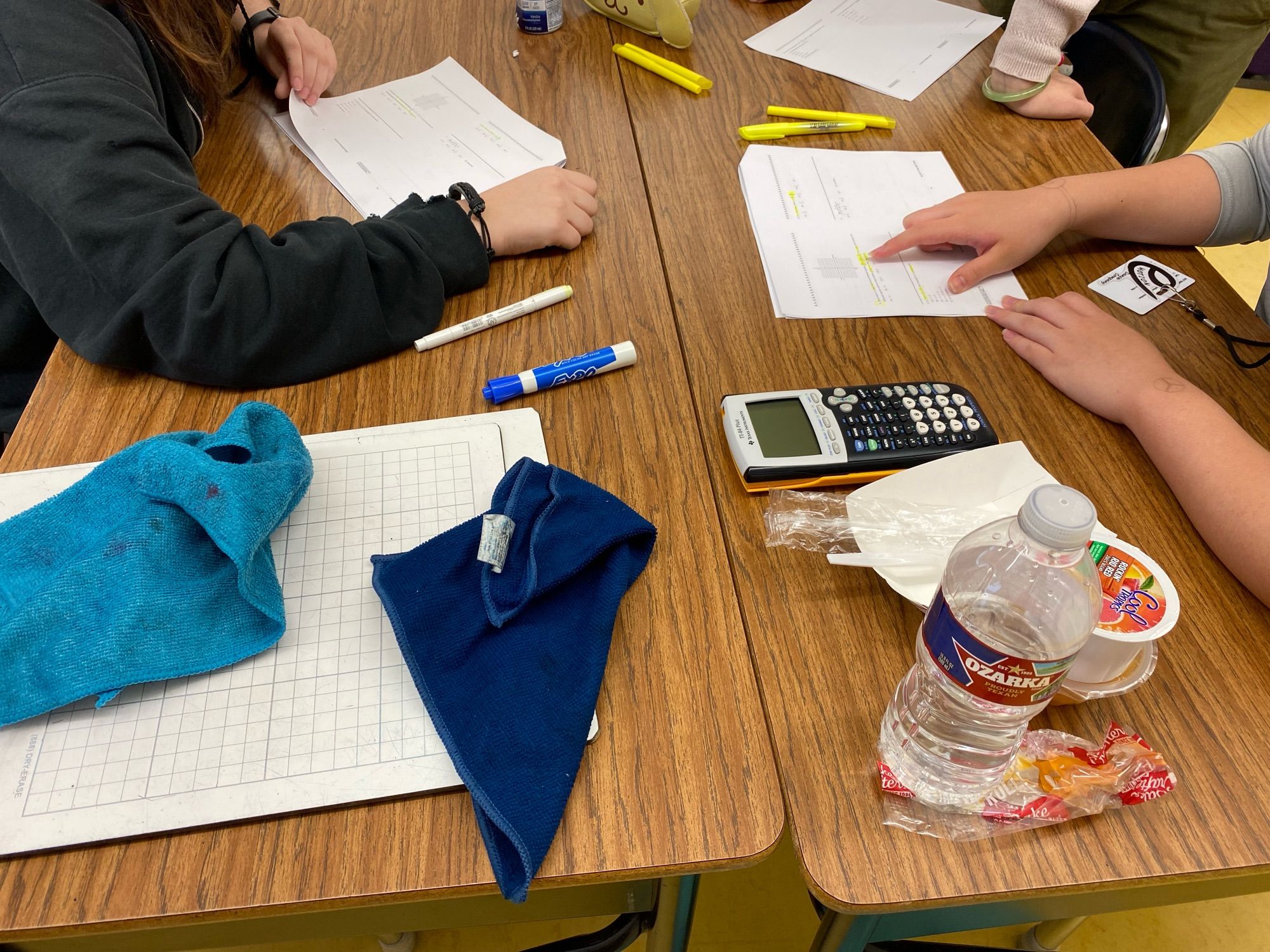 Students at a table discussing test without writing.