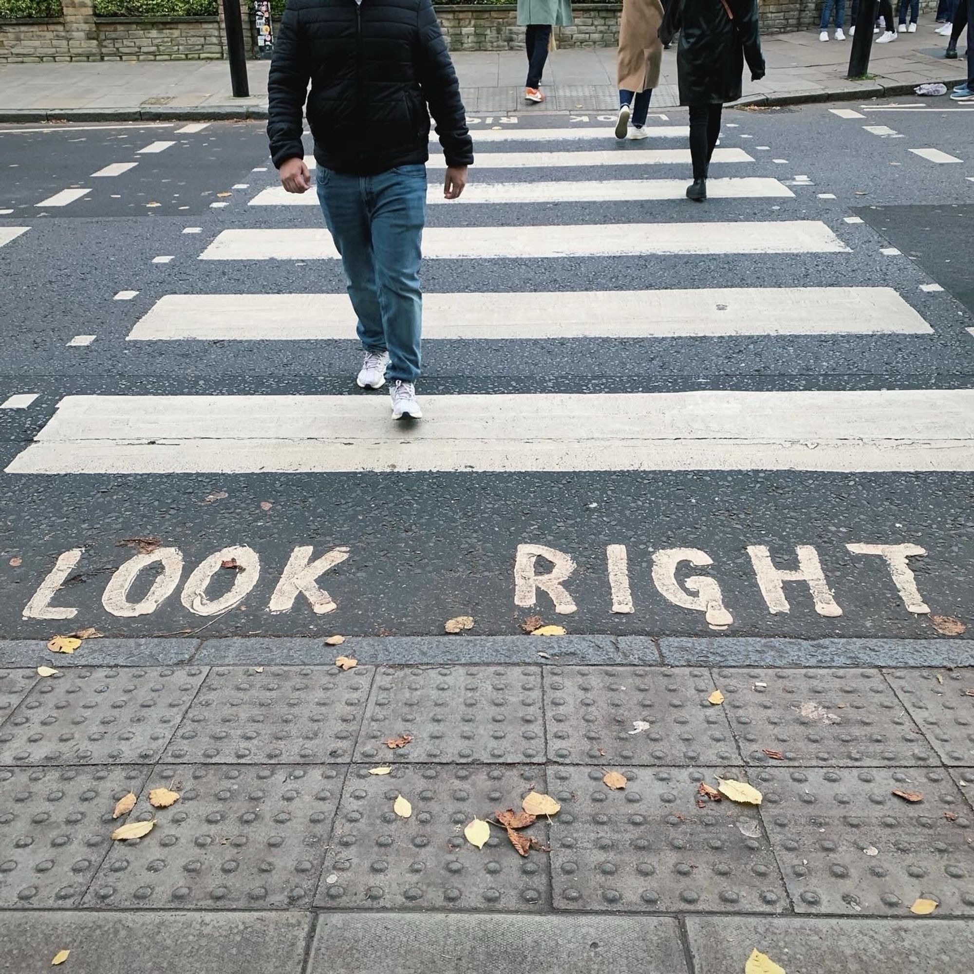 The Abbey Road Crosswalk, with some people walking on it