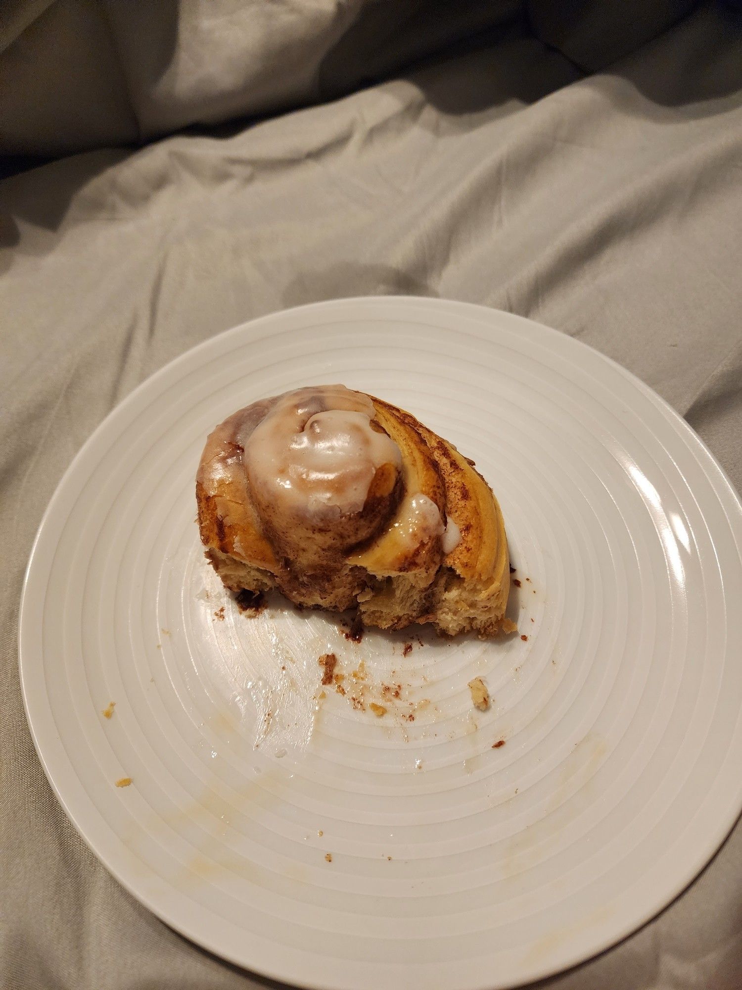 Picture of the partially eaten cinnamon roll. Most of the cummy parts have been eaten