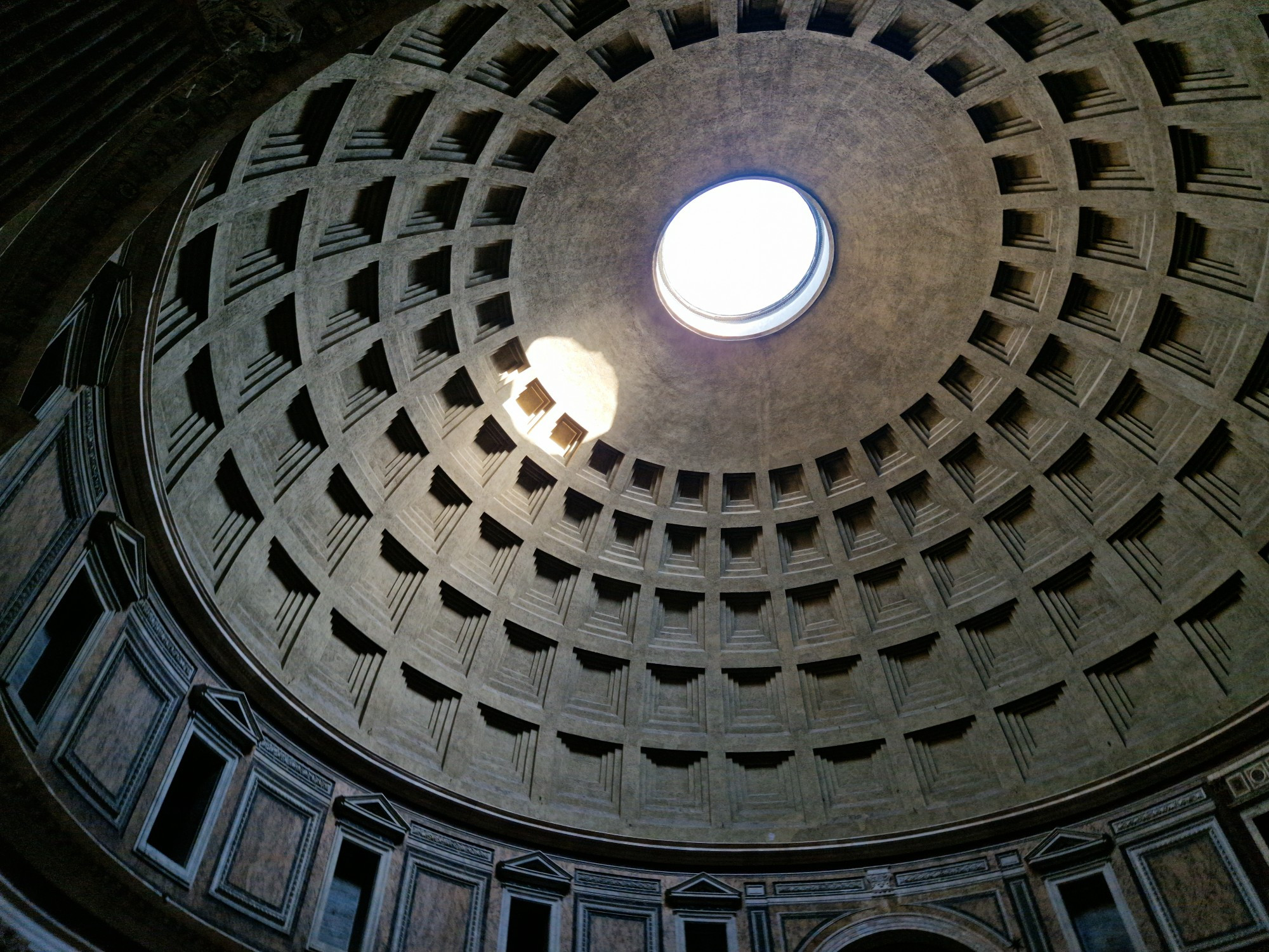 Ceiling of the Pantheon's dome, with light shaft across the surface