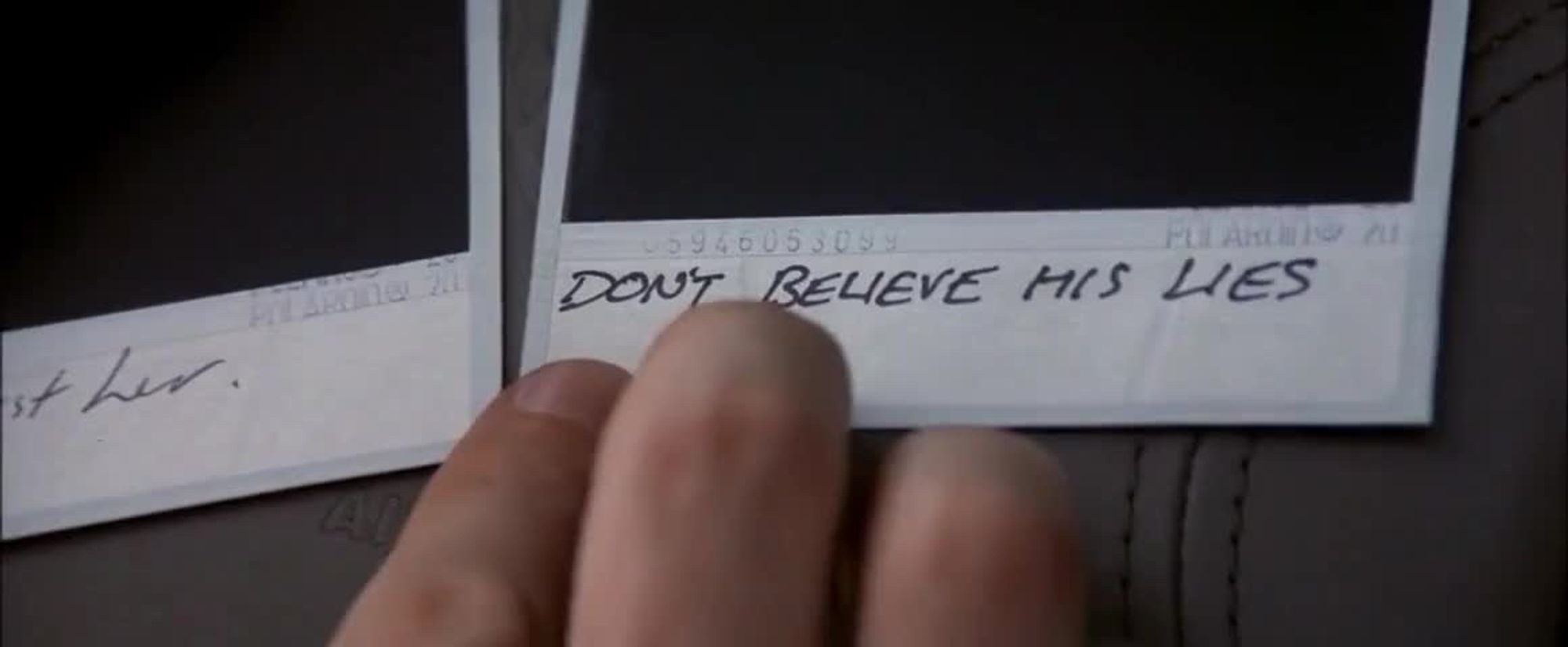 Close-up from Memento of a Polaroid captioned “Don’t believe his lies”