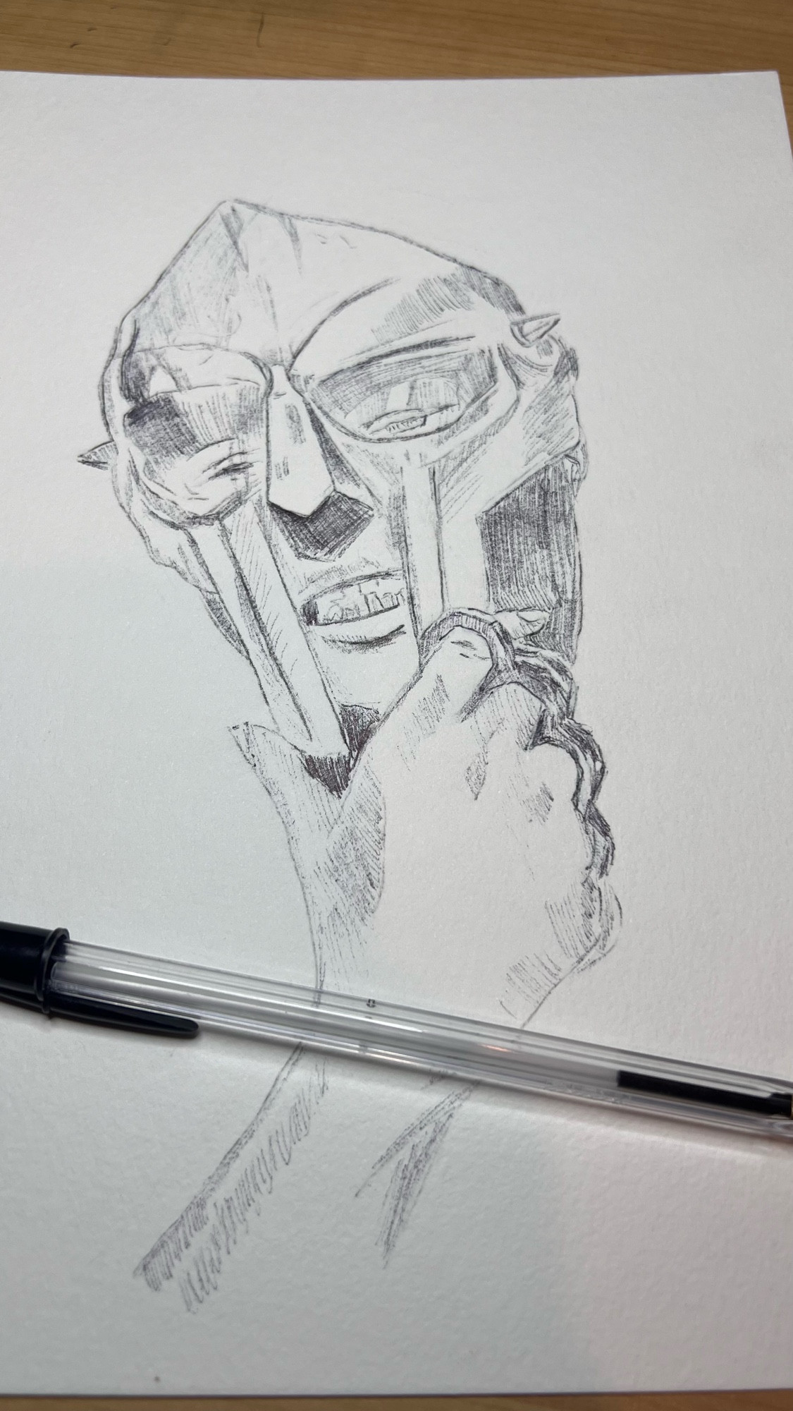 WIP -Ballpoint pen portrait of MF Doom. He’s wearing his mask and some brass knuckles.