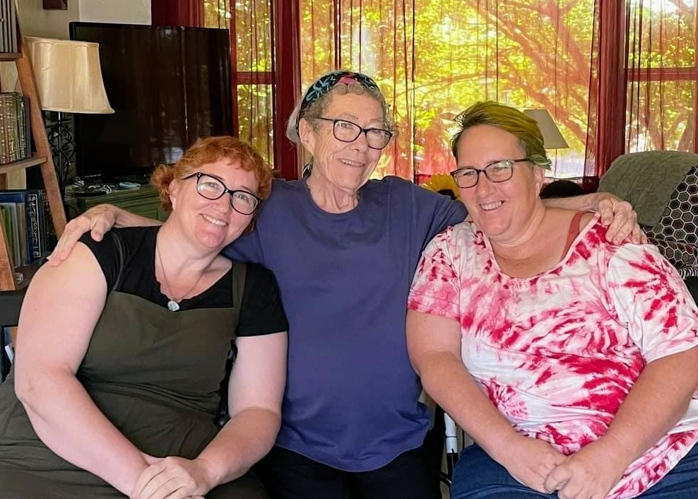 Three women with attached earlobes