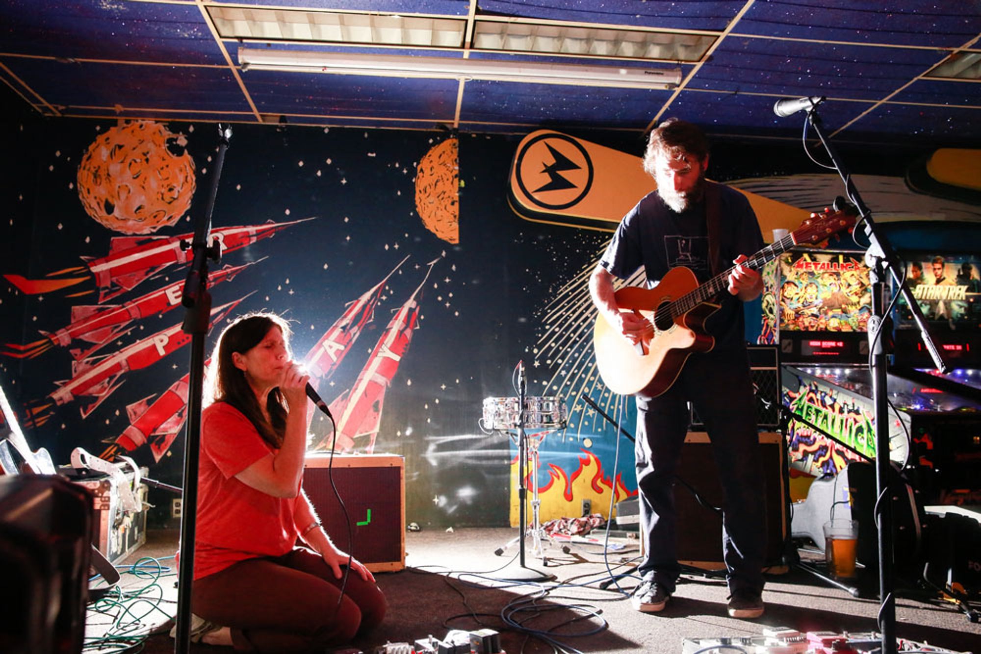 Photo of R. Ring playing in some sort of Pinball Paradise.