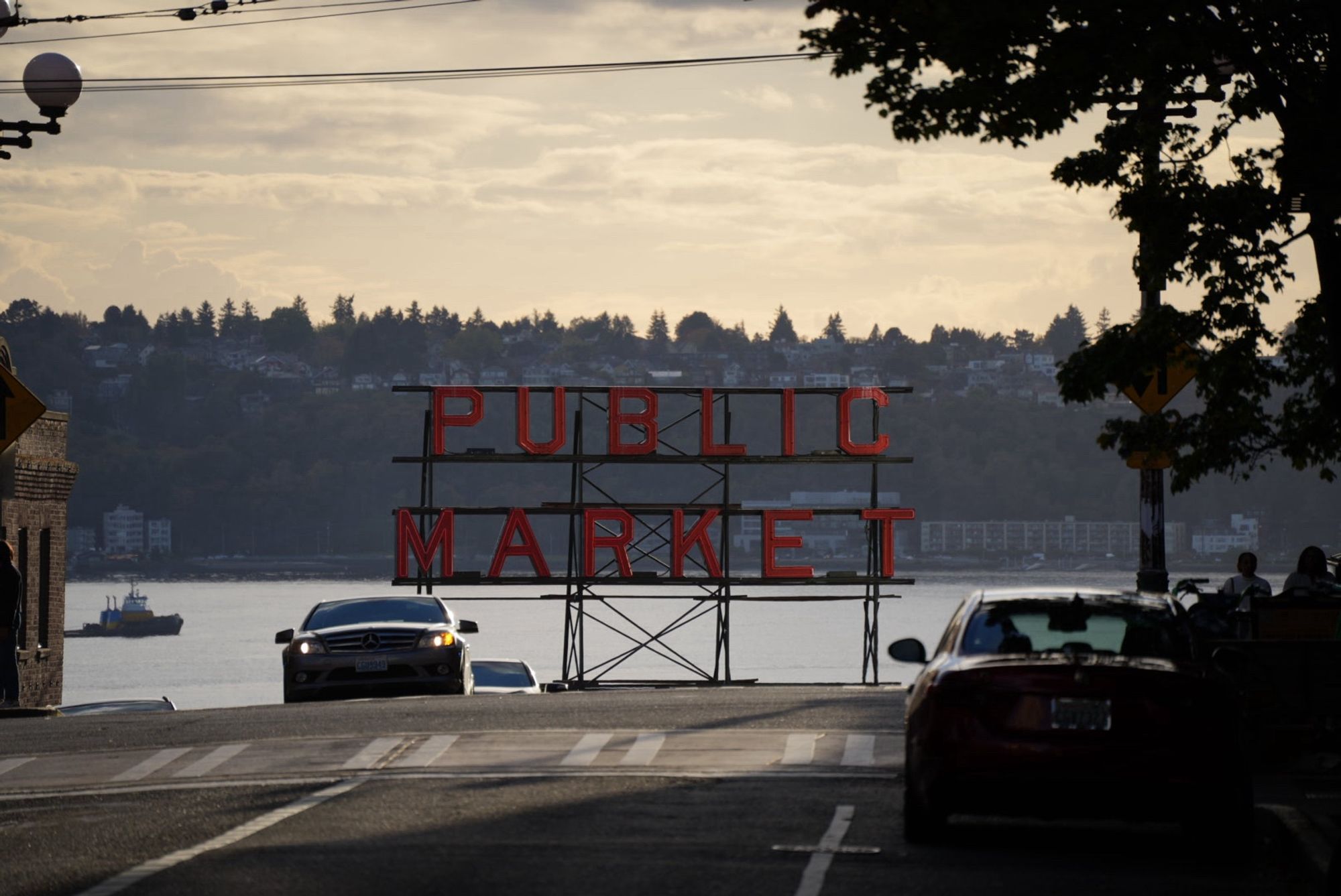 Pike place public market sign with distant trees