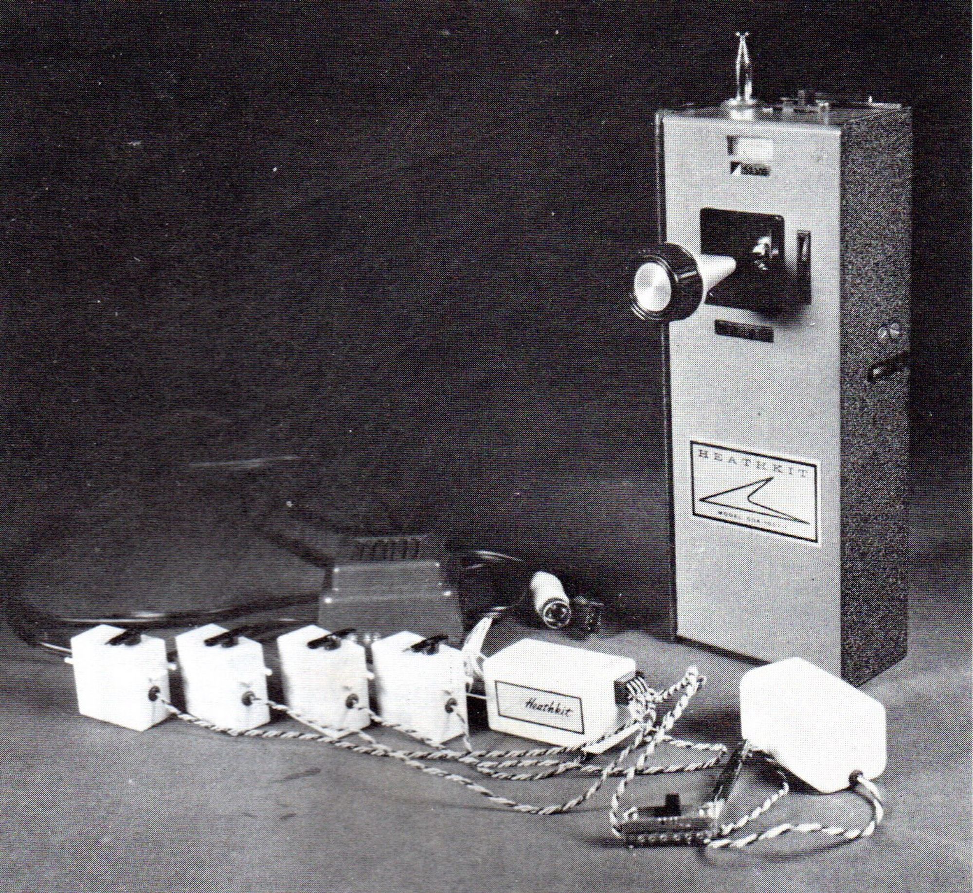 A black-and-white image of a Heathkit GDA-1057 model airplane radio-control transmitter along with servos, receiver and battery for same. This appears to be an image from one of their magazine advertisements.