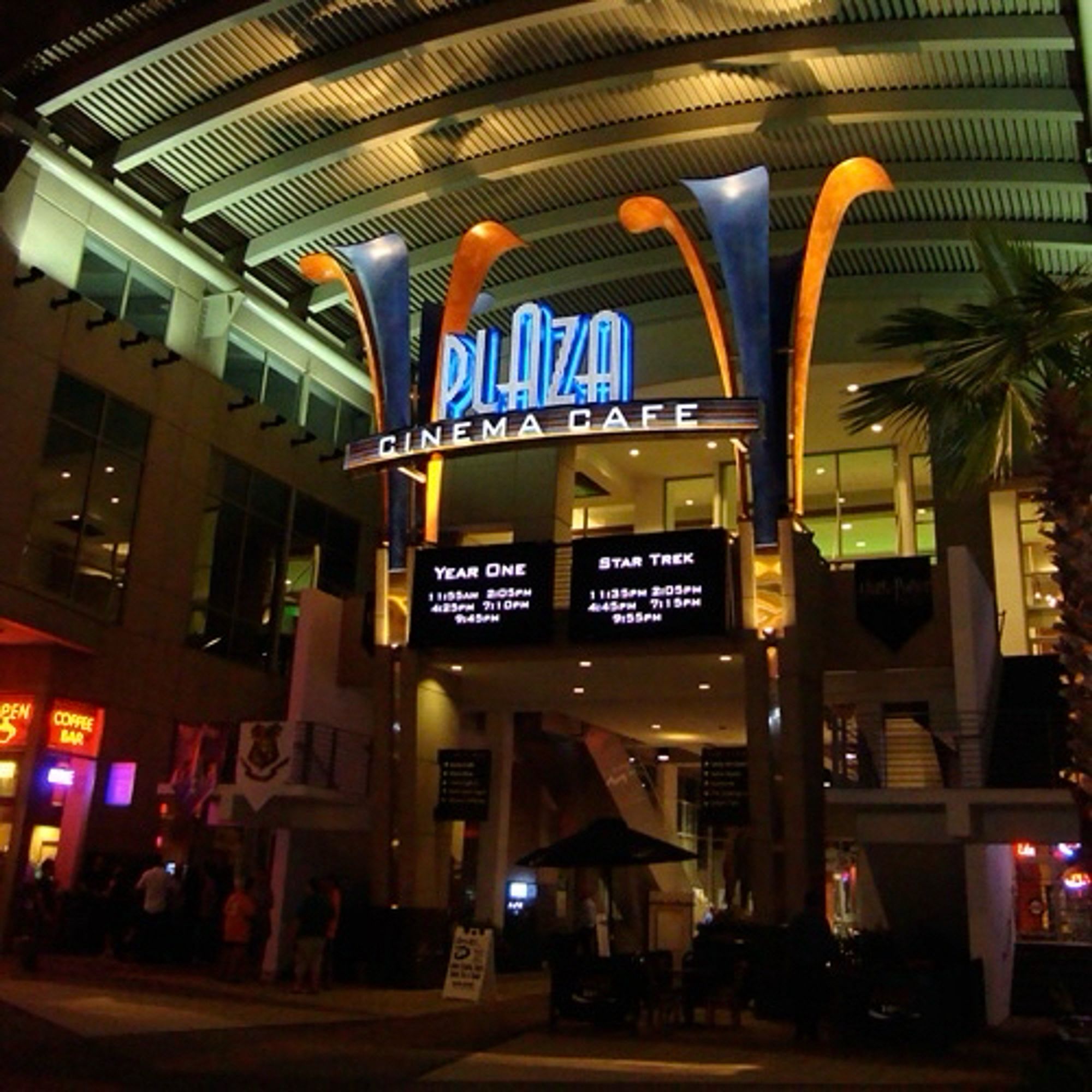 Exterior photograph at night of the Plaza Cinema Cafe in downtown Orlando, Florida