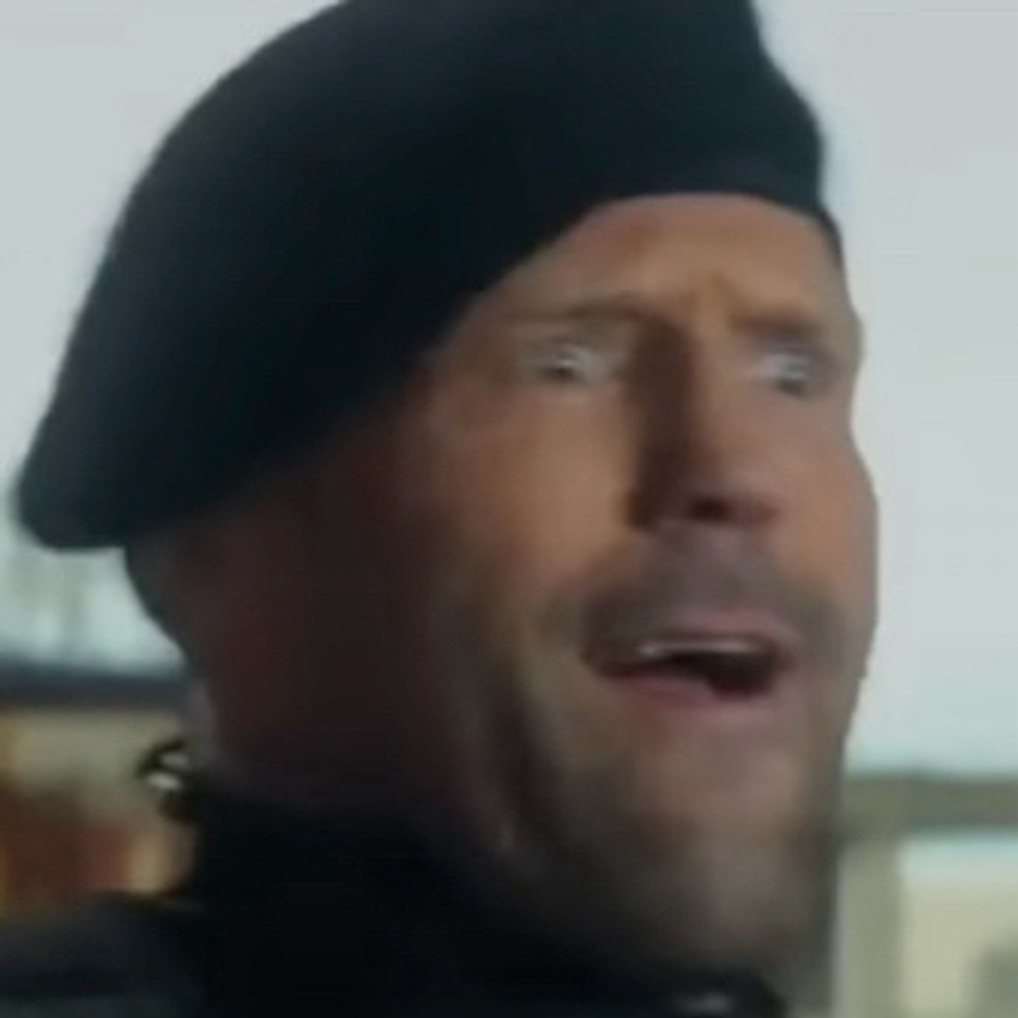 cropped still of Jason Statham with an absurd look on his face in a terribly rendered green screen from EXPEND4BLES