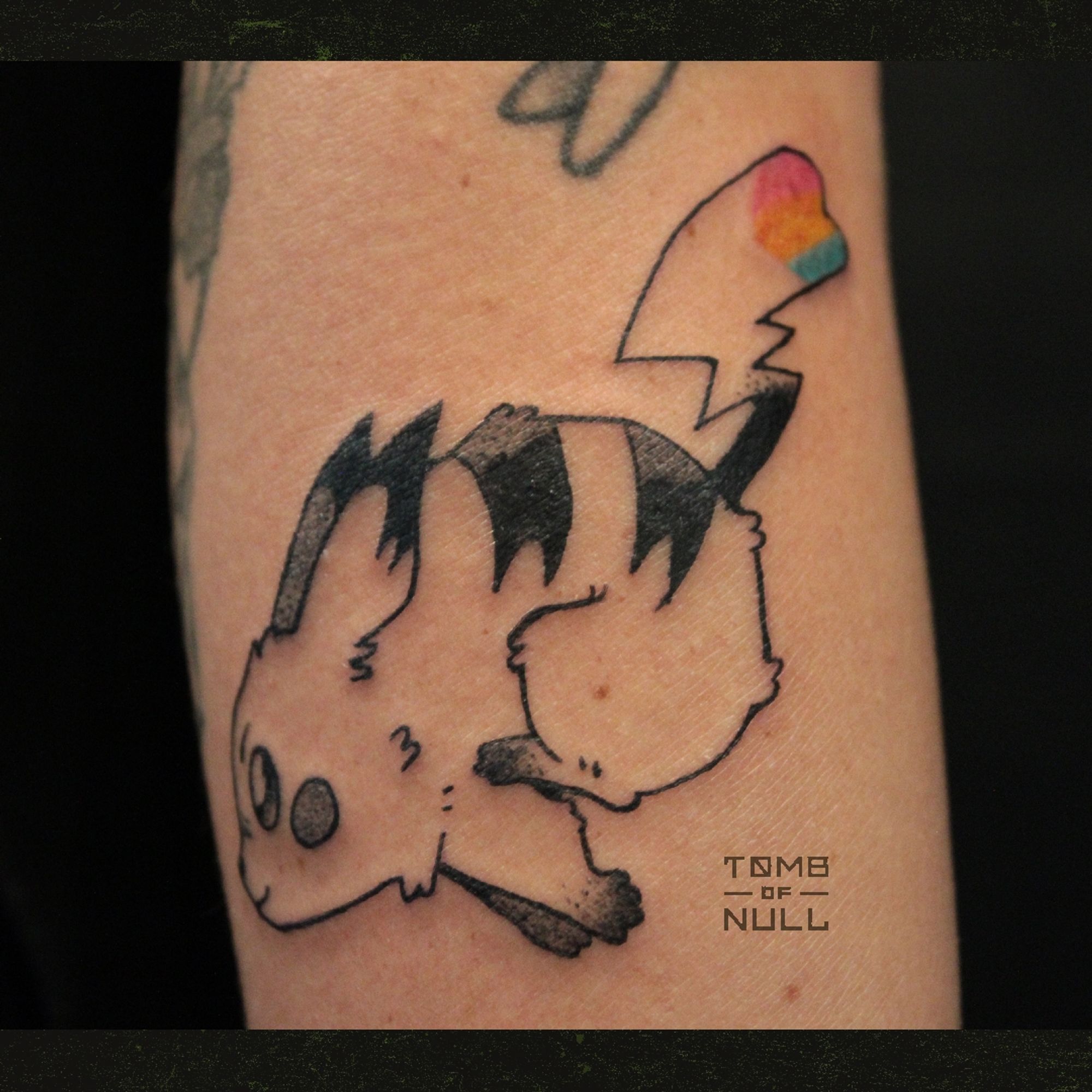 A fresh tattoo of a dashing pikachu done on pale skin. Her tail is heart shape, and bares the pansexual flag colors.A fresh tattoo of a dashing pikachu don on pale skin. Her tail is heart shape, and bares the pansexual flag colors.