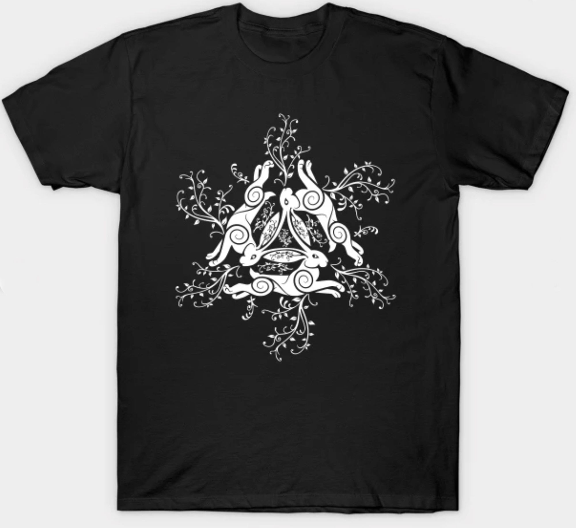 black t-shirt with white art showing the 3 hares with swirls and flower growing from them. hard to see in this image is the eyes of the hares are the Sun, the Moon, and the Stars.