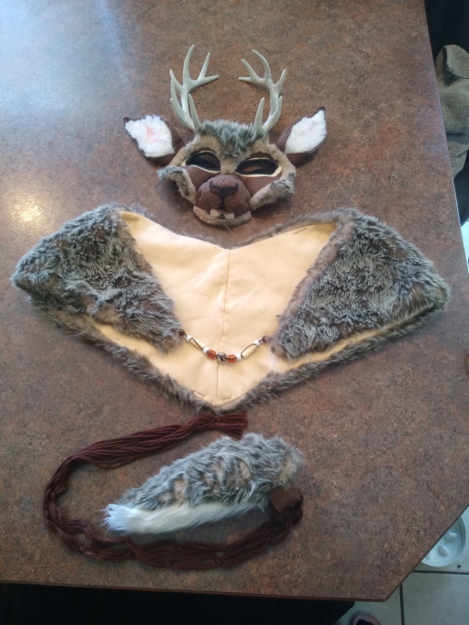 a deer costume set laying out on a counter