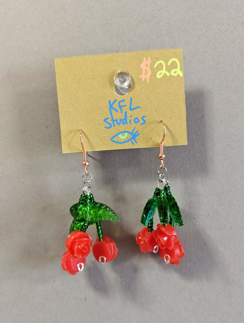 a pair of glass and resin rose earrings, tripled up to form small bunches, made by myself!