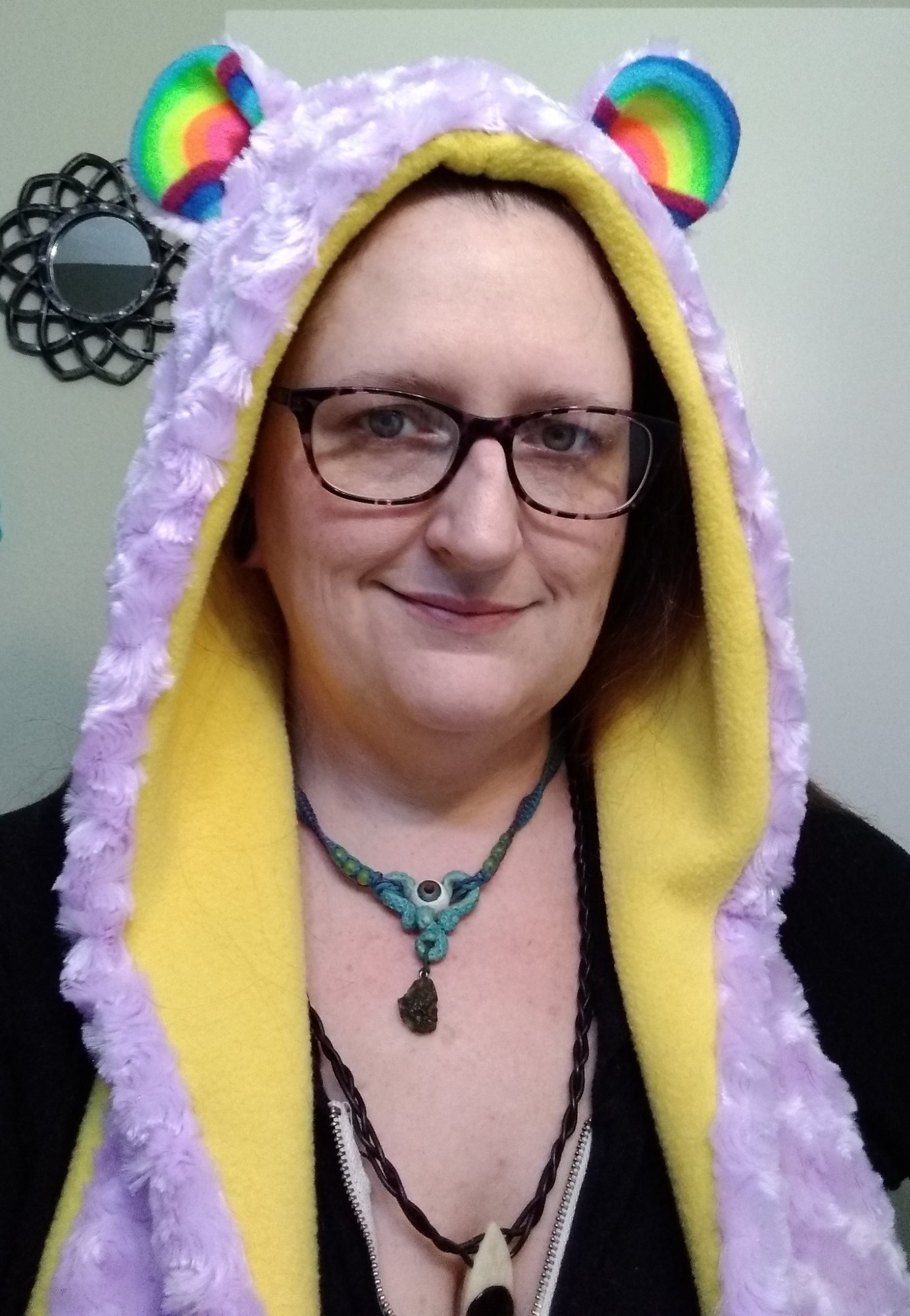 here is the rainbow ears hood, made from soft light yellow fleece and lavender purple rosette-cut minkie fur, with rainbow fleece ears and (not pictured) two large pockets with paw pads!