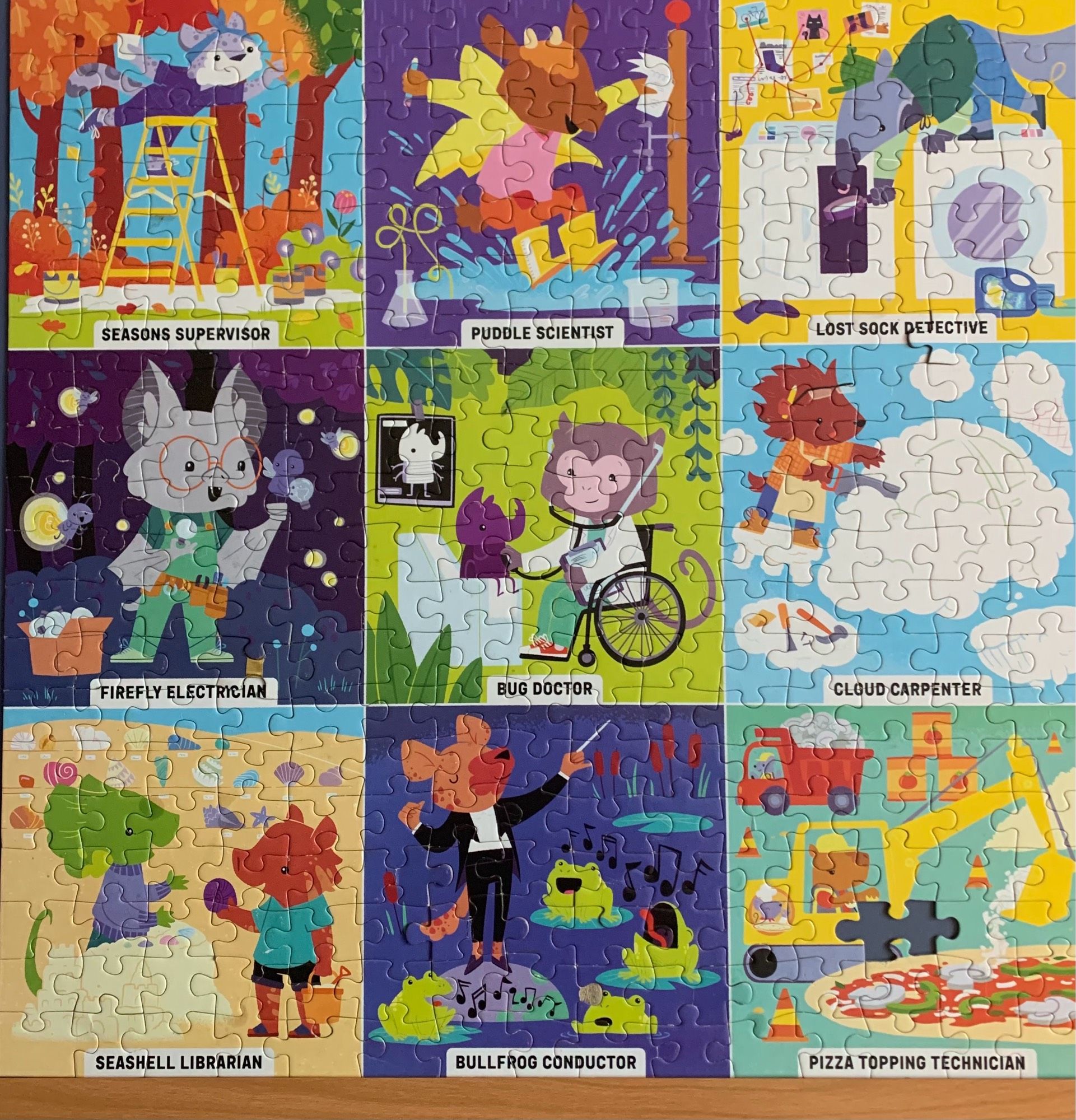 300 piece jigsaw puzzle with 9 panels, each representing and cartoon animal doing a whimsical job. The jobs are : Seasons Supervisor, Puddle Scientist, Lost Sock Detective, Firefly Electrician, Bug Doctor, Cloud Carpenter, Seashell Librarian, Bullfrog Conductor, and Pizza Topping Technician.