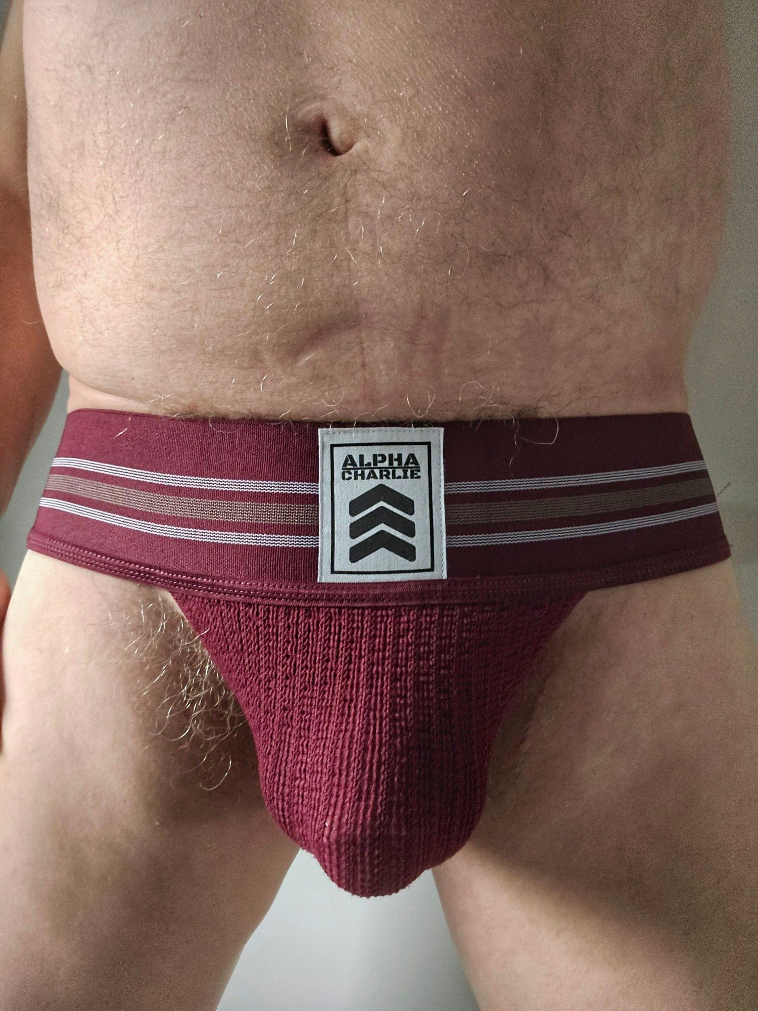 Wideband burgundy Alpha Charlie jockstrap from the front showing my bulge