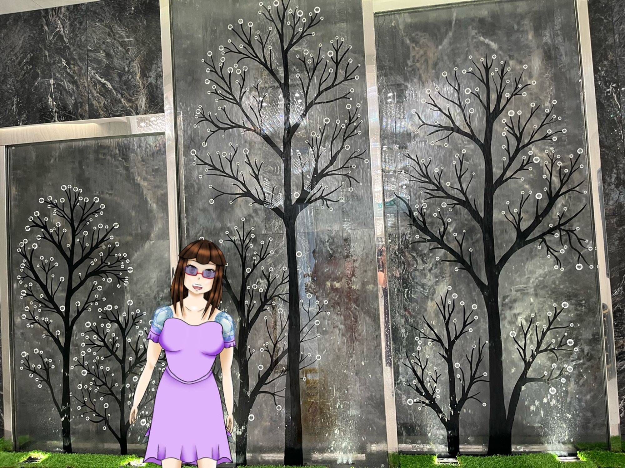 Crystal’s model in front of a mechanical waterfall. with the background of black trees with white flowers are the end of the branches.