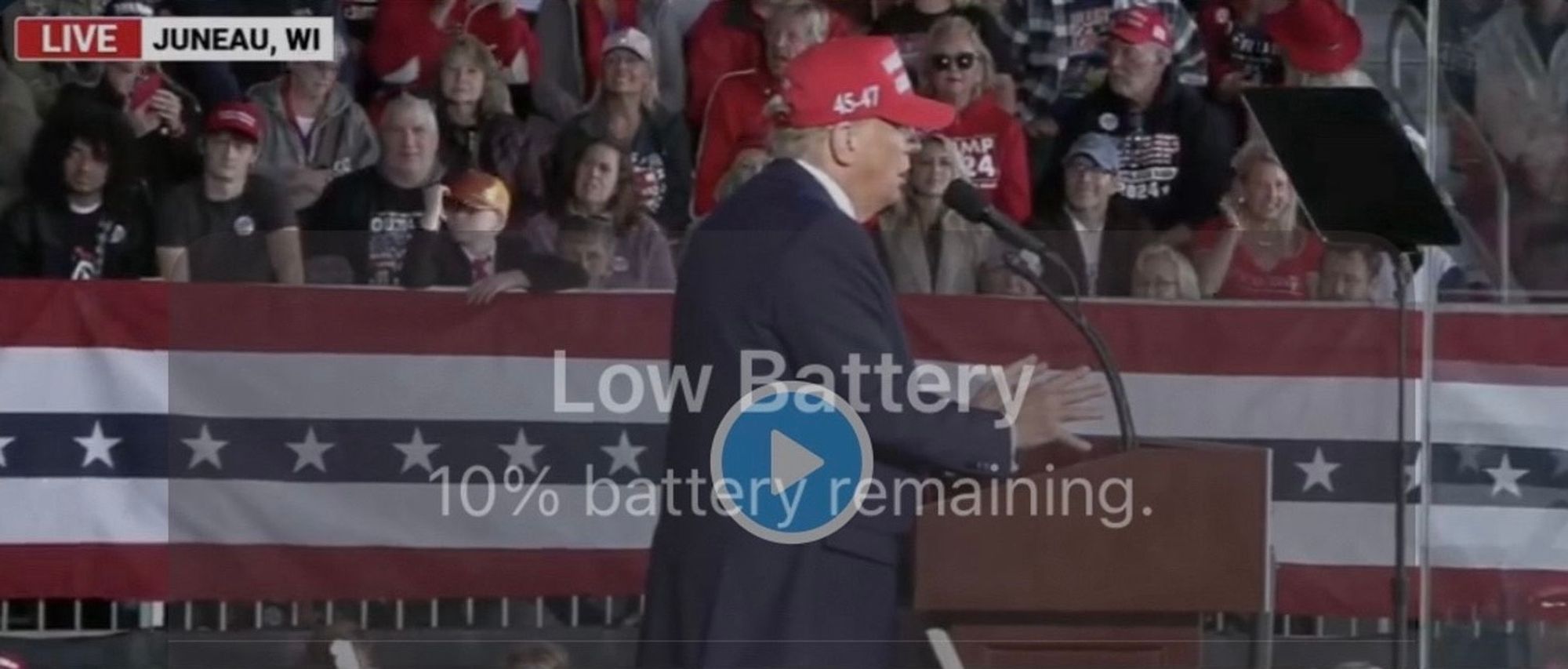 Screenshot of video of Trump at rally with message “Low Battery 10% battery remaining.”