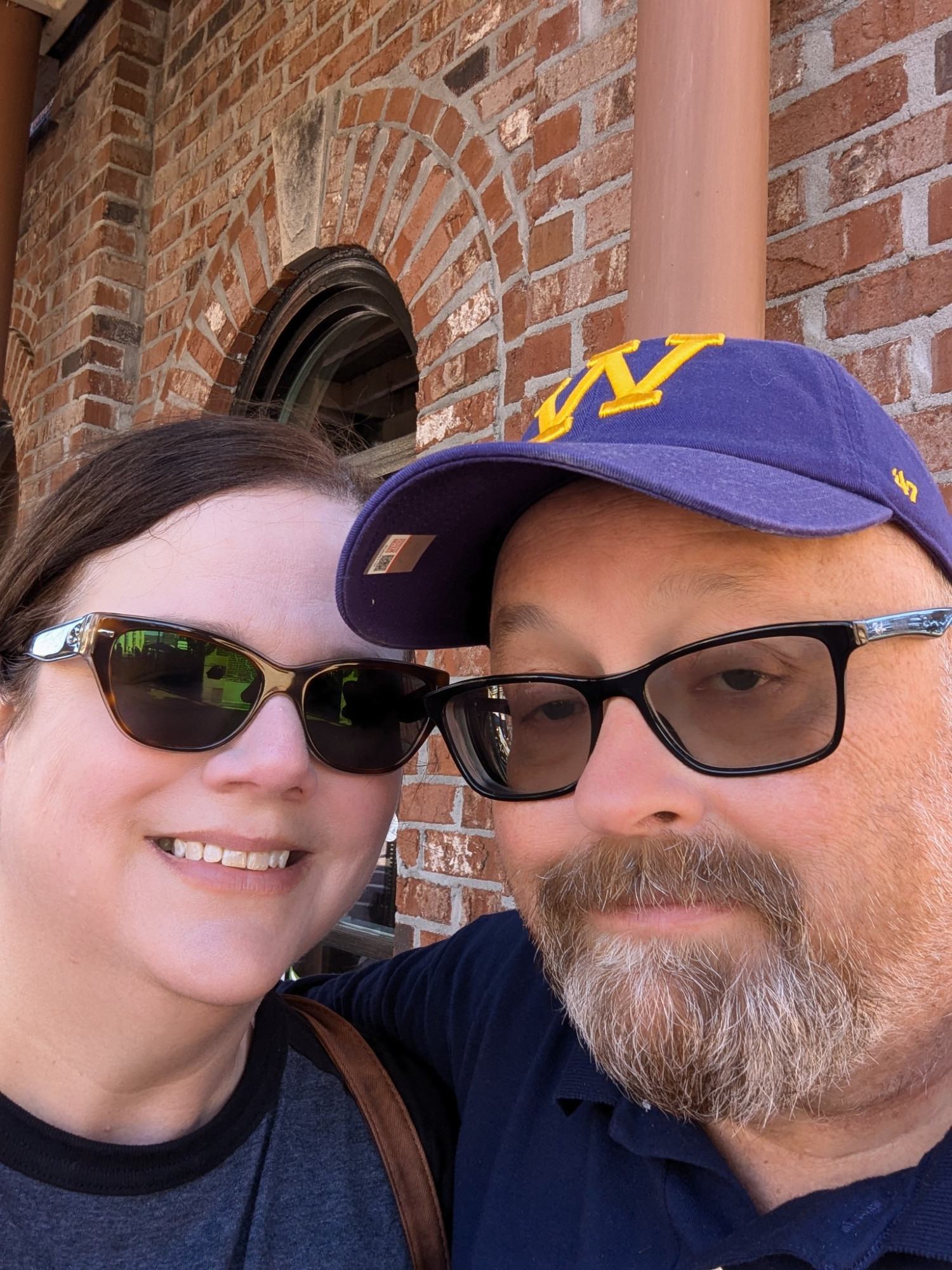 My wife and I selfie in front of a brick building