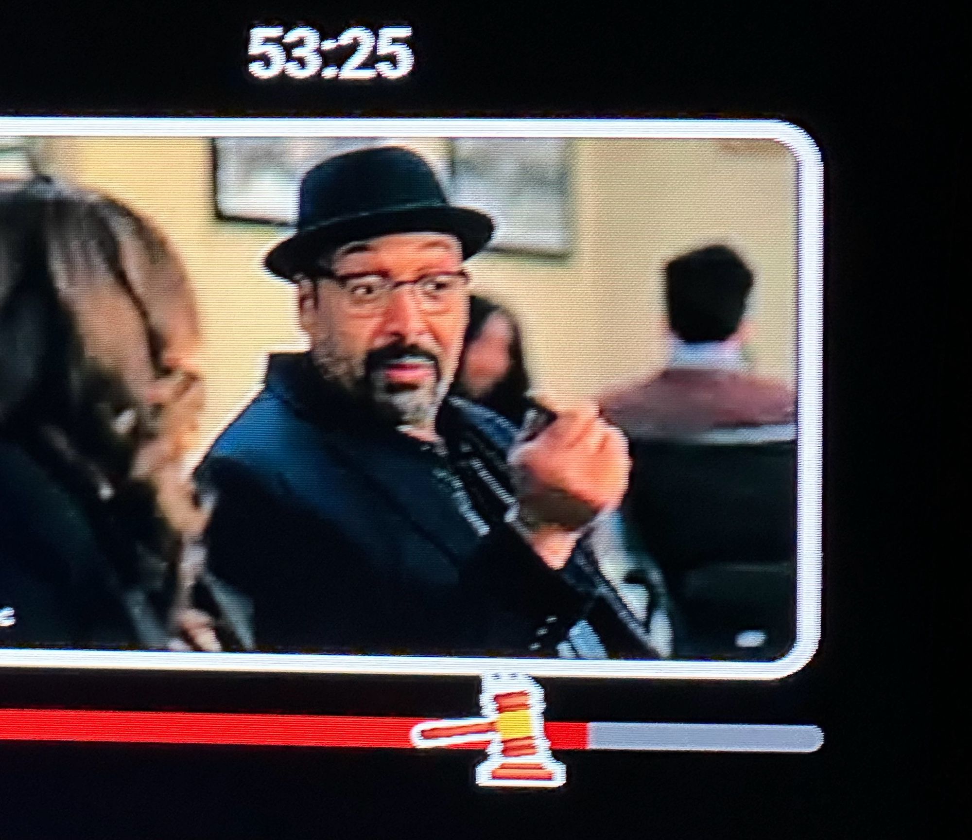 The fast forward bar at the bottom of a TV screen tuned to YouTubeTV during an episode of SVU. In place of a forward arrow, there’s a gavel icon, with the gavel moving down against the wooden base. Above the bar is a small picture inset with a promo for The Irrational featuring Jesse L Martin, which isn’t relevant to what this photo intends to highlight, but is there nonetheless 