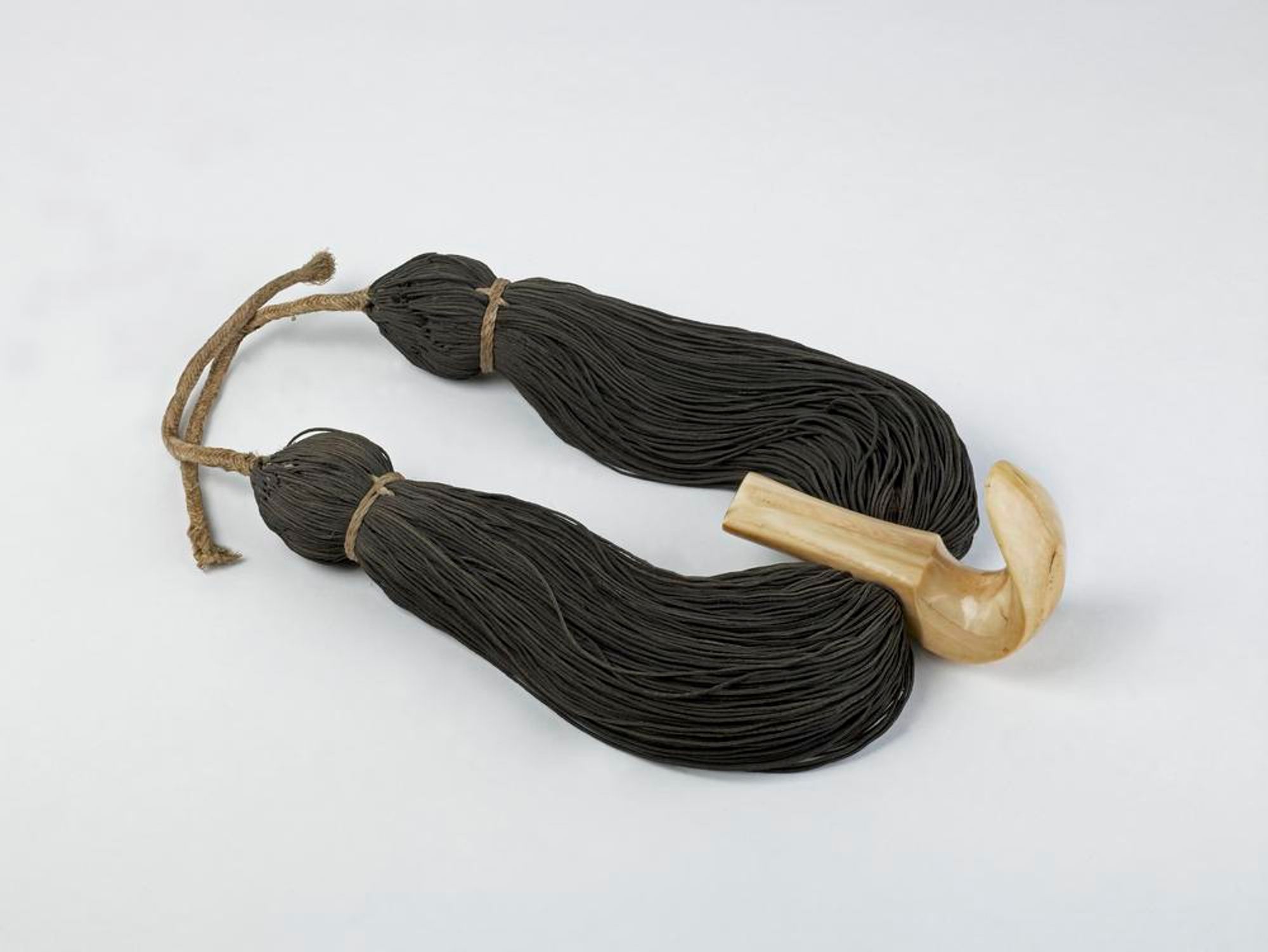 Lei niho palaoa  photo. Necklace made from human hair and whale tooth carved into a stylized fishook (perhaps).