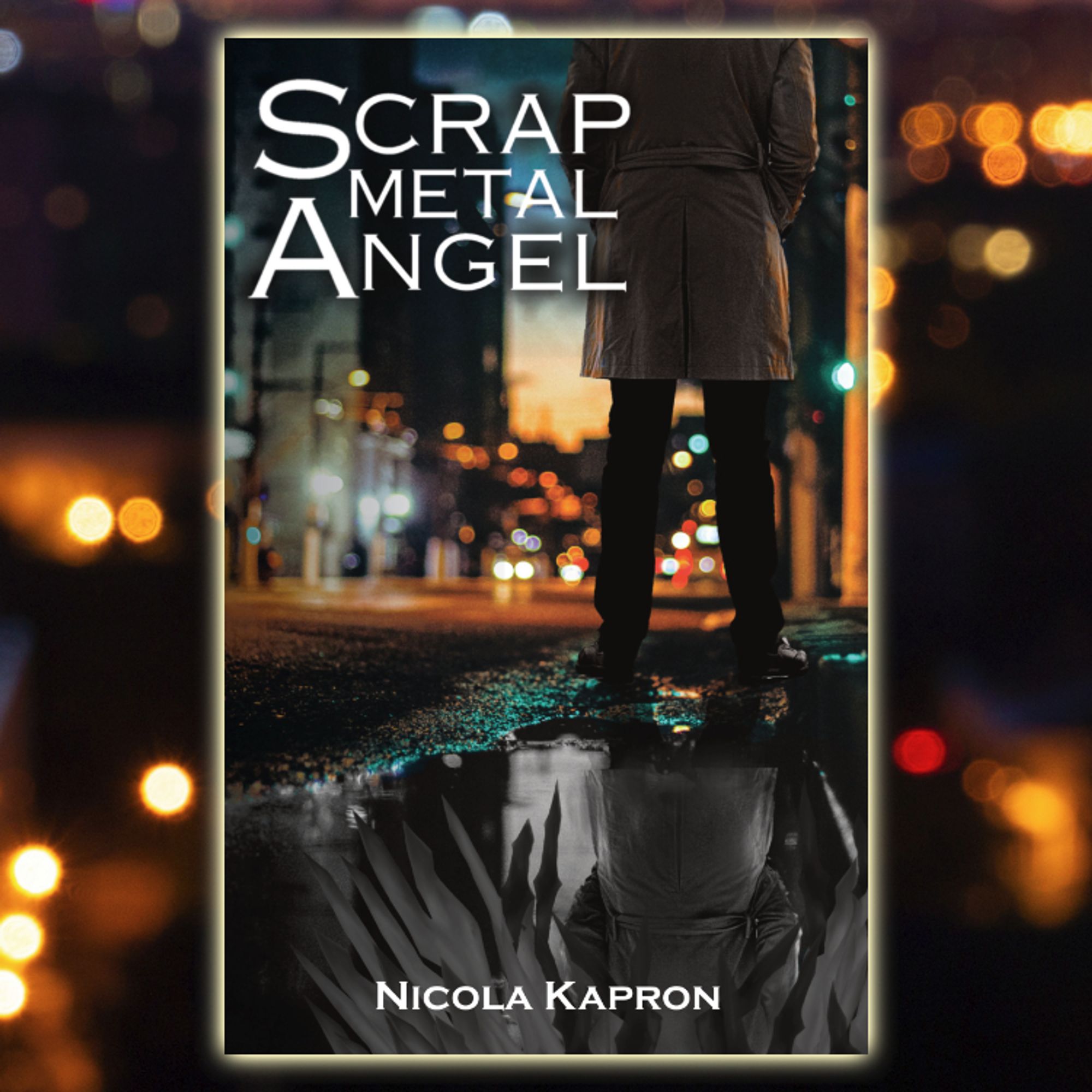 A photomanipulation book cover. The title of the book is Scrap Metal Angel, and the author is Nicola Kapron. The image shows a blurred out street. In the foreground, a person stands, shown from the shoulder down, their legs spread. They are wearing a trench coat, trousers, and shows. Their shoes are right at the edge of a large puddle that shows their reflection. The reflection is grayscale, and adds industrial-looking wings that are not visible outside the reflection.