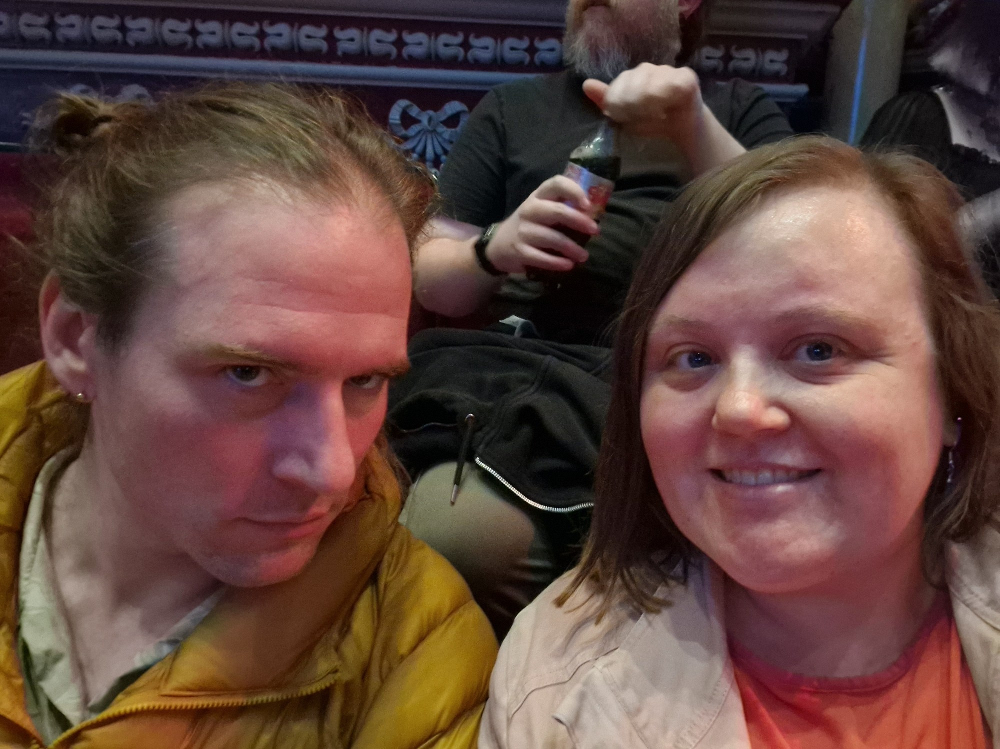 A picture of two people sat in the RAH. The man is posing and then woman is smiling