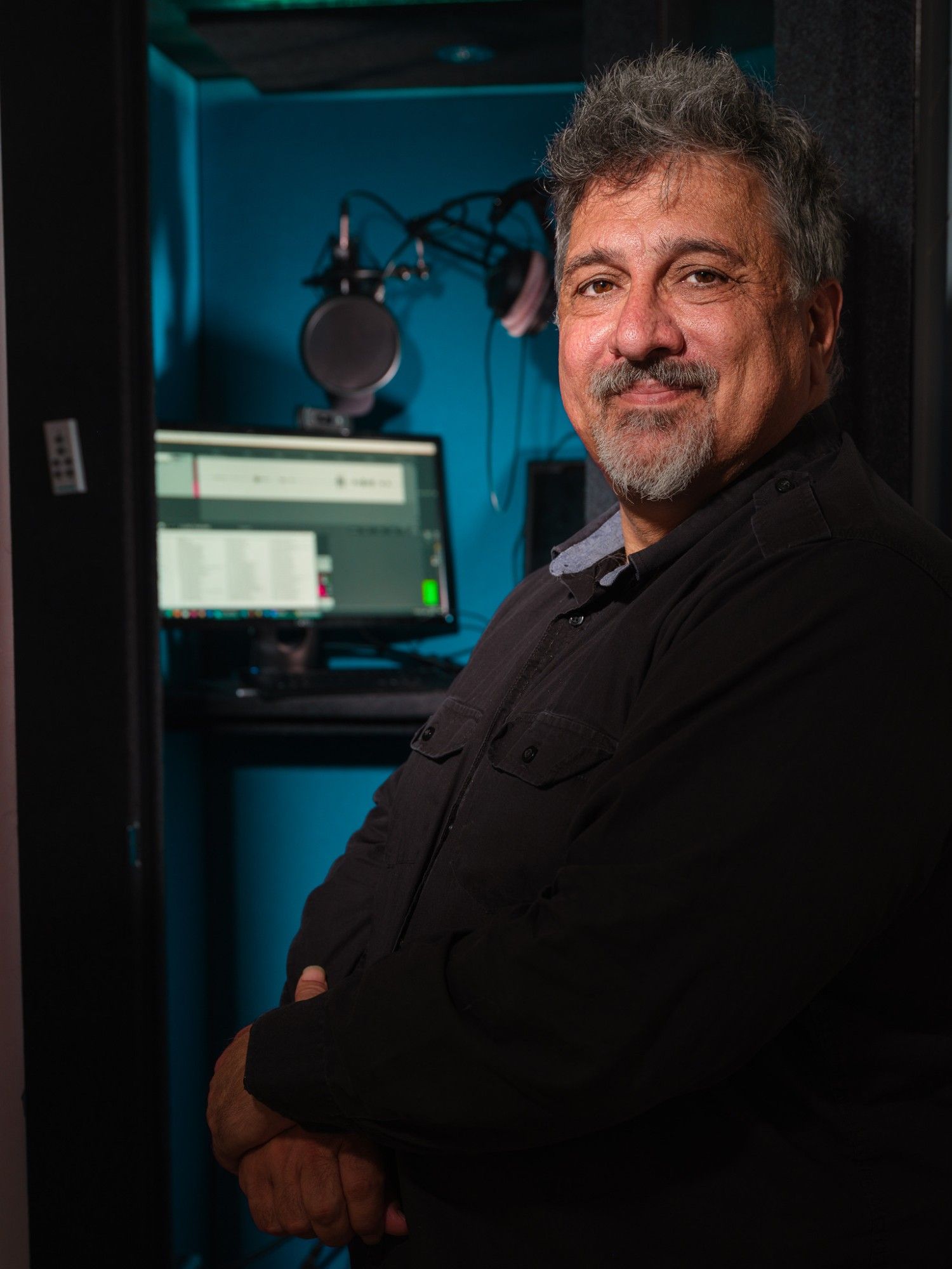 Karim standing in front of his recording booth