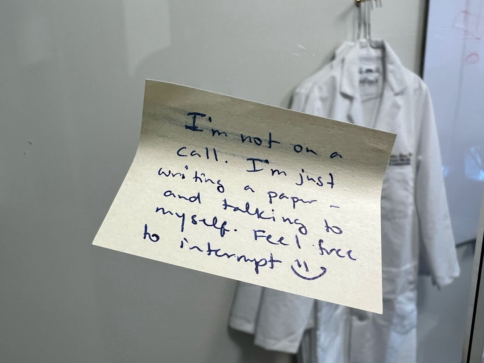 Note on office door. "I'm not on a call. I'm just writing a paper - and talking to myself. Feel free to interrupt. :)"