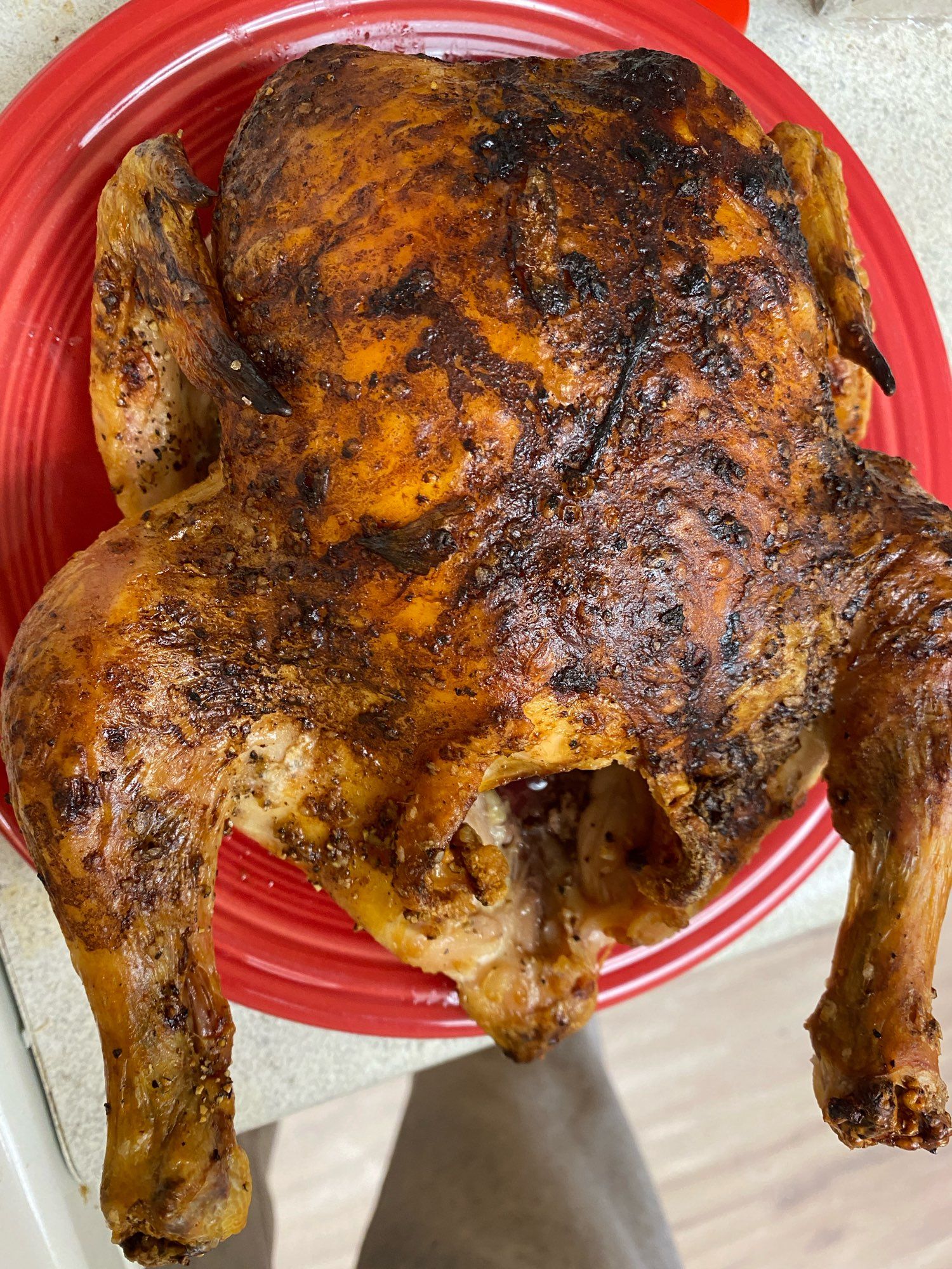 Tonight’s roast chicken with a lovely shiny dark brown skin resting on a plate.