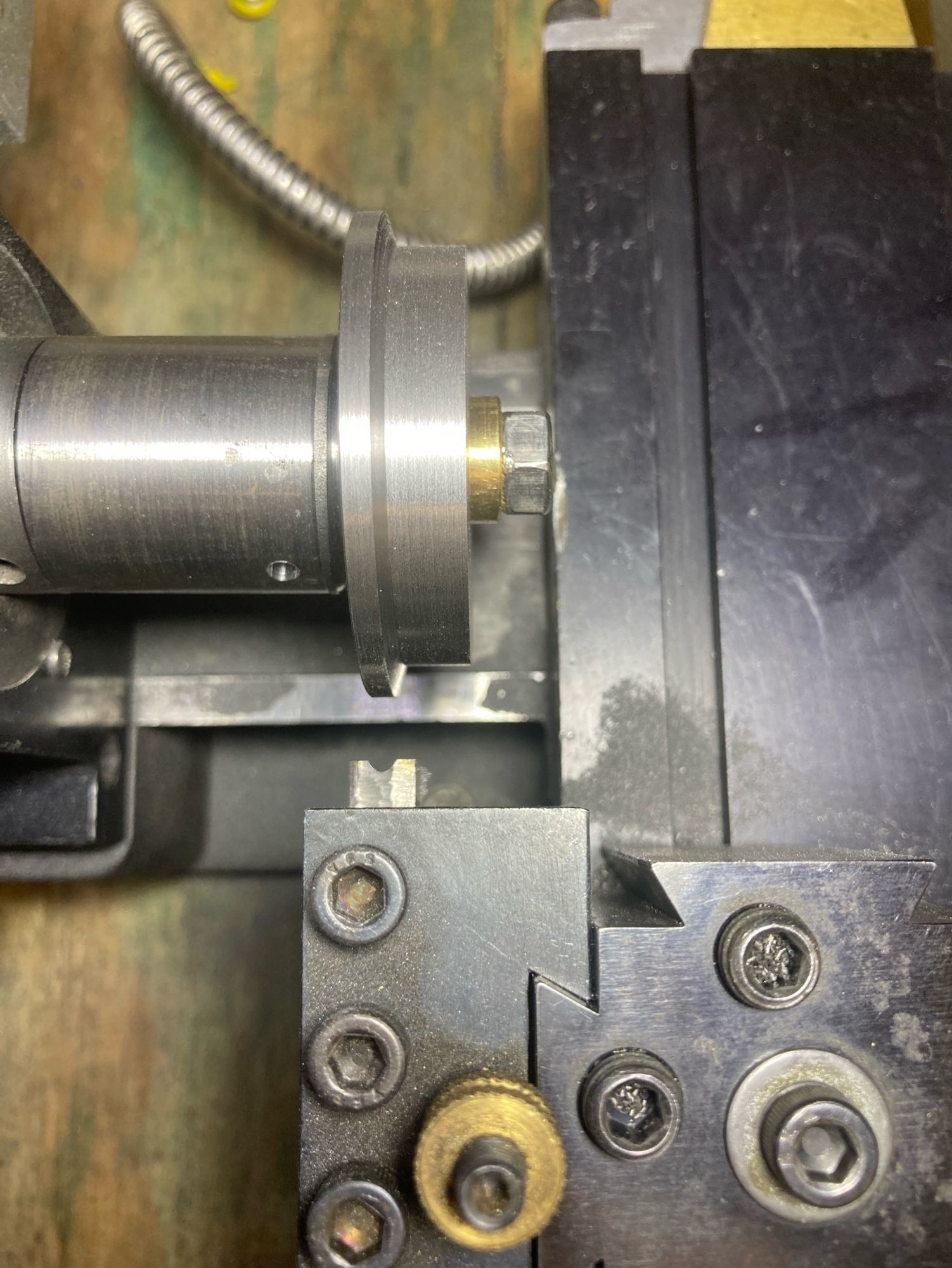 Top view of a wheel blank mounted on a mandrel in a lathe. At the bottom of the picture is a custom shaped form tool.