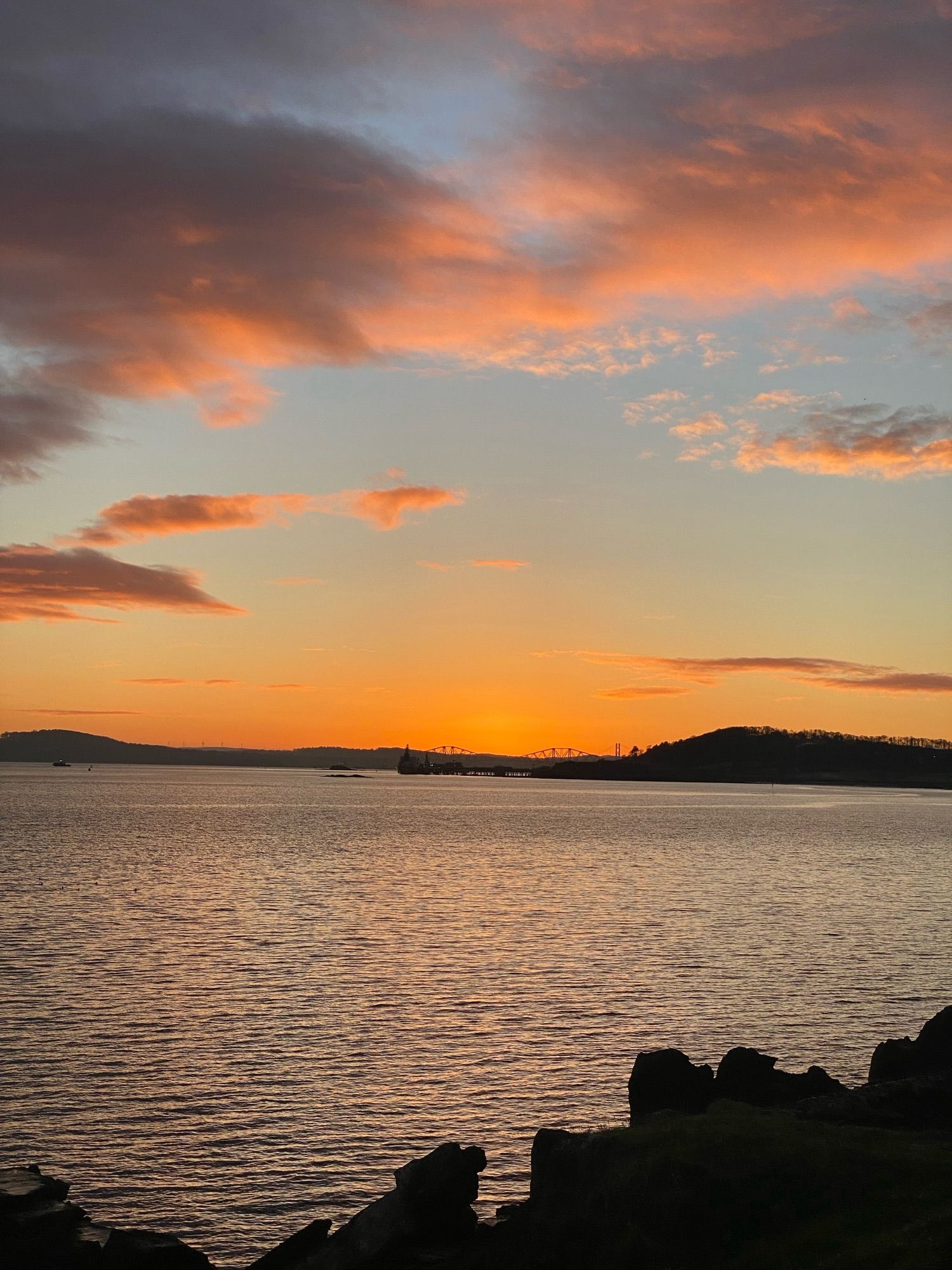 Golden hour: rose gold clouds at sunset over the sea