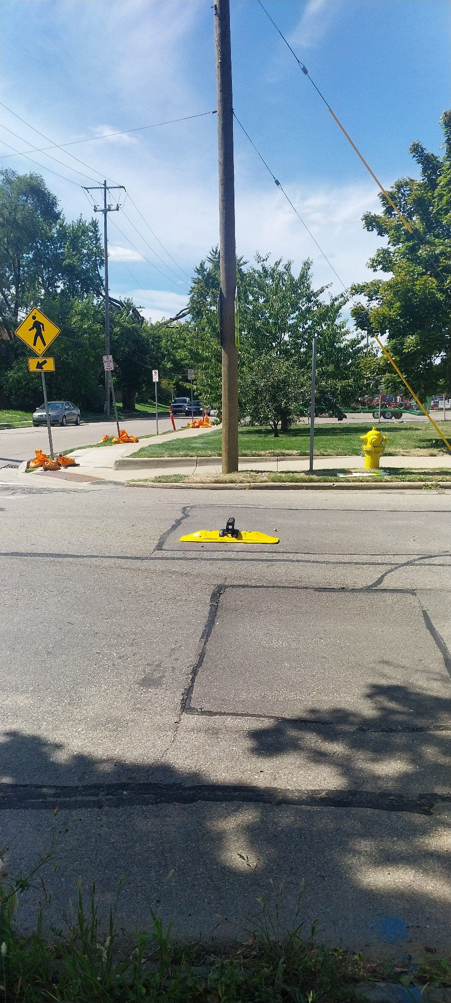 A "stop for pedestrians" mid-road sign emplacement. Now minus the sign.