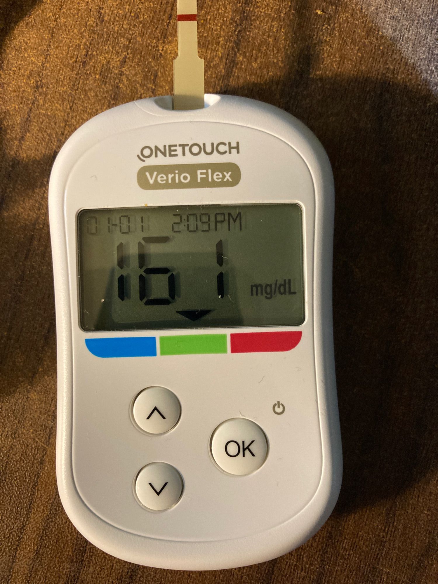 One touch Verio Flex blood sugar meter with a test strip inserted and reading the blood sugar as 161 mg/dL on 01-01 at 2:09pm.