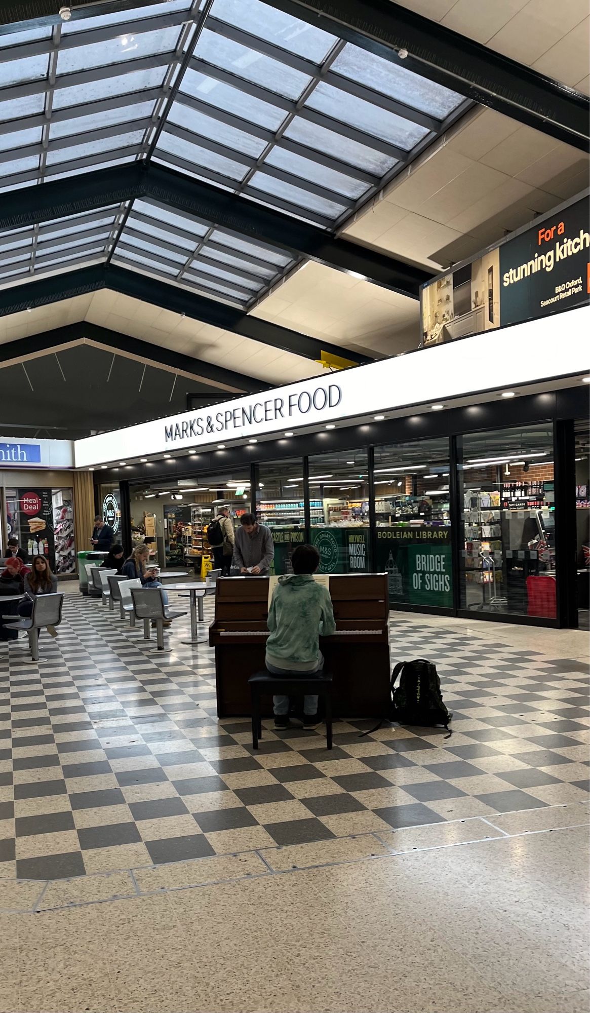 Piano with pianist playing on station concourse