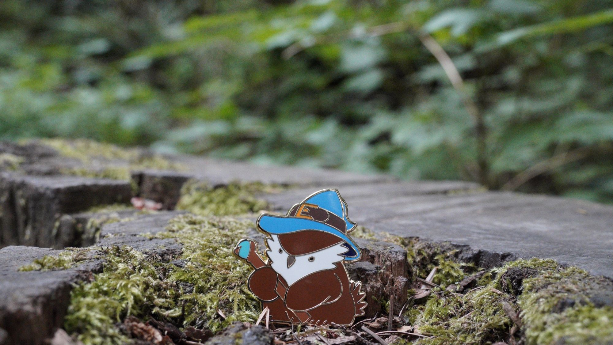 A pin of an owlbear wizard pin in the forest