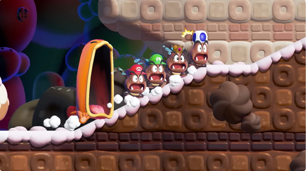 A screenshot from the Maw-Maw Mouthful stage in Super Mario Wonder, showing a Maw-Maw chasing Mario, Luigi, Princess Peach and Toad, who are all in Wonder Flower-induced Goomba forms.