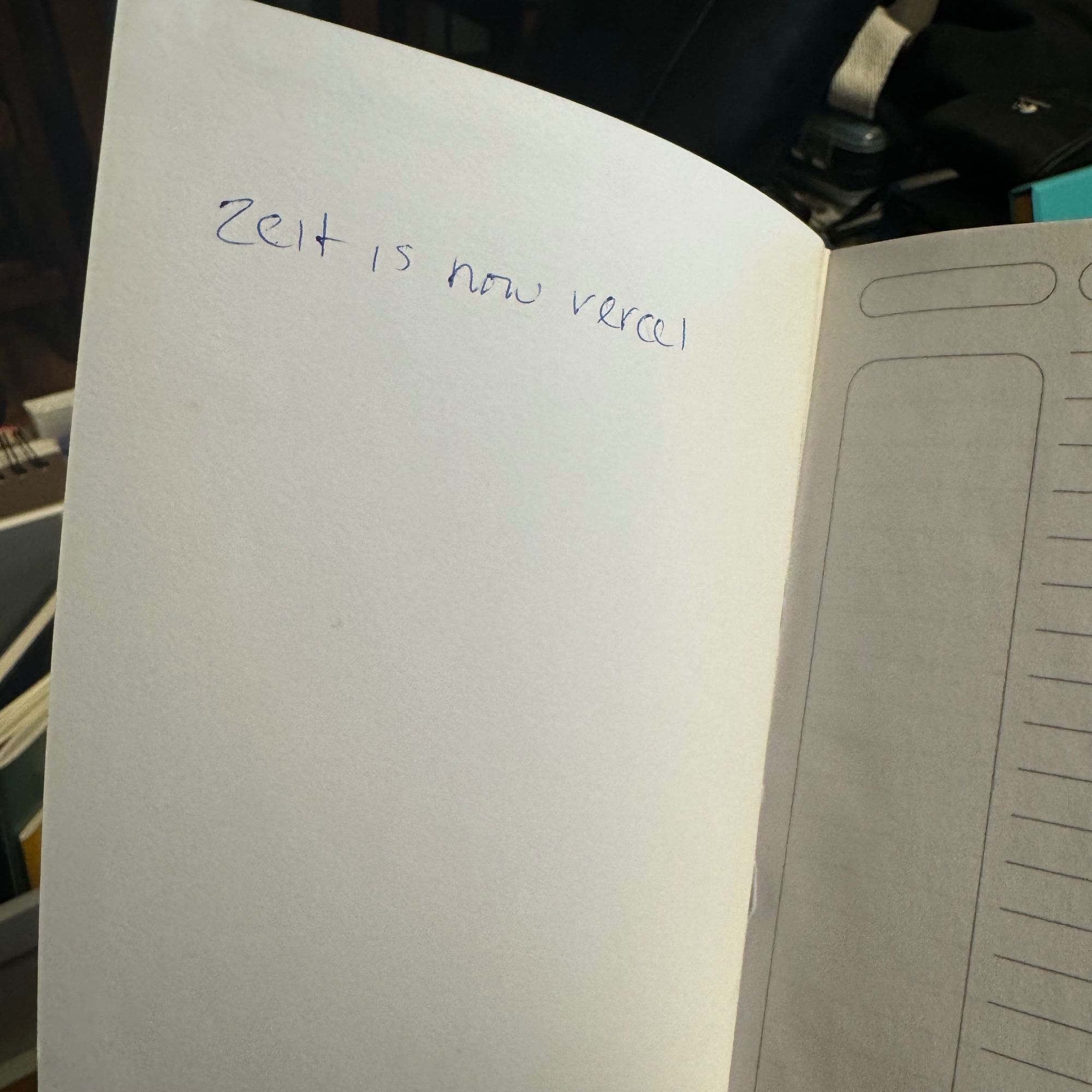 Photo of an open notebook and the inside flap just says in my handwriting, “zeit is now vercel”