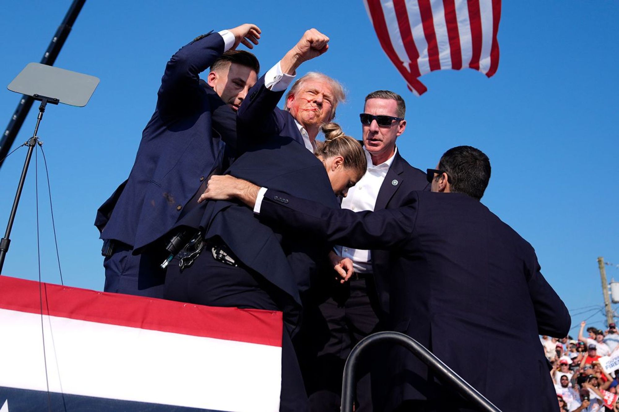 Very staged looking photo CNN of Donald trump waving his first triumphantly beneath the stars and Stripes 
Link to the article 
https://edition.cnn.com/politics/live-news/election-biden-trump-07-13-24/index.html