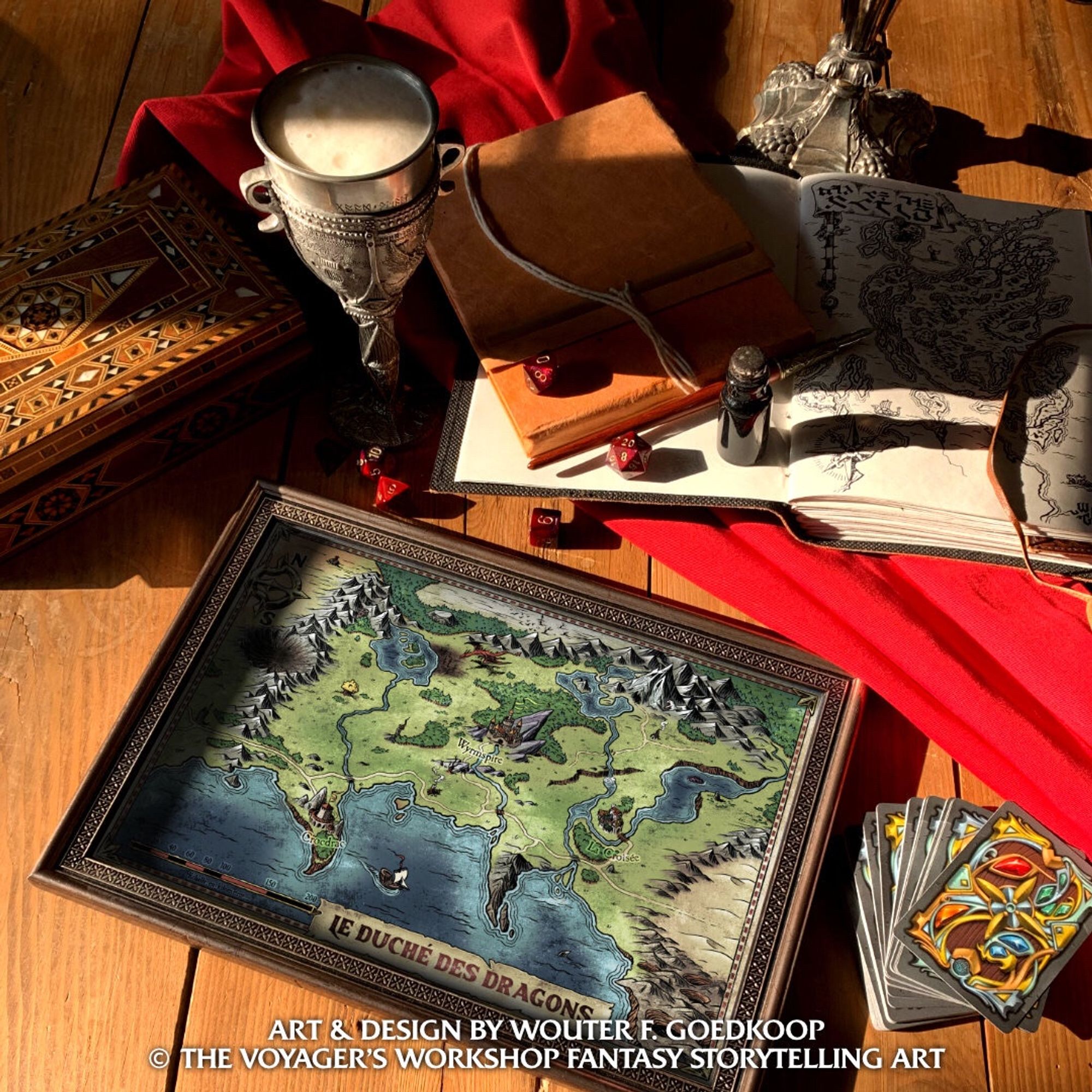 An evocative tabletop with pewter cups filled with ale, notebooks, dice, cards and an evocative fantasy map filled with storytelling seeds.