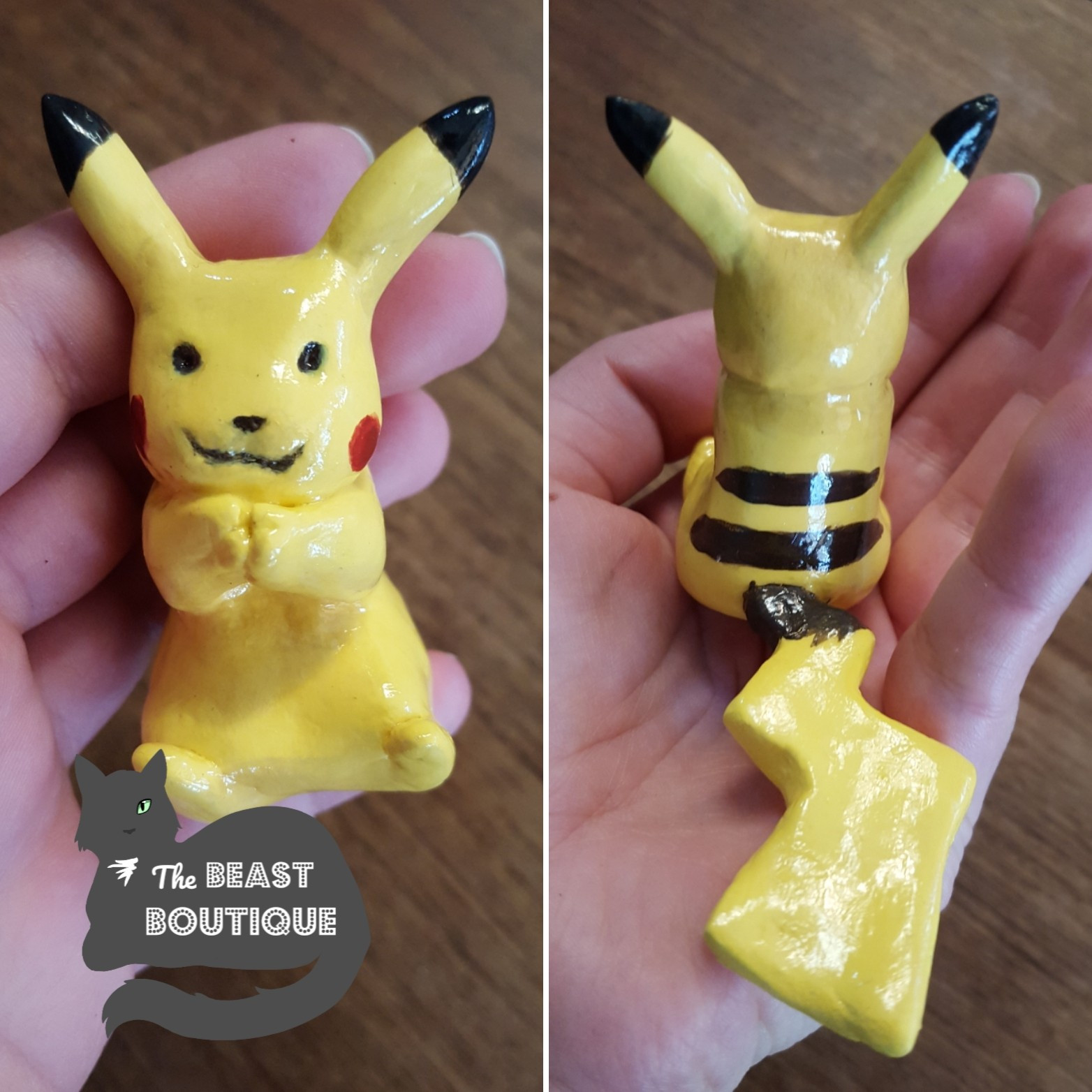 A Pikachu figurine. It is sitting with its tail out flat behind it, and its hands are clasped in front of it under its chin. It's painted yellow, with black stripes on its back, and red cheeks. 