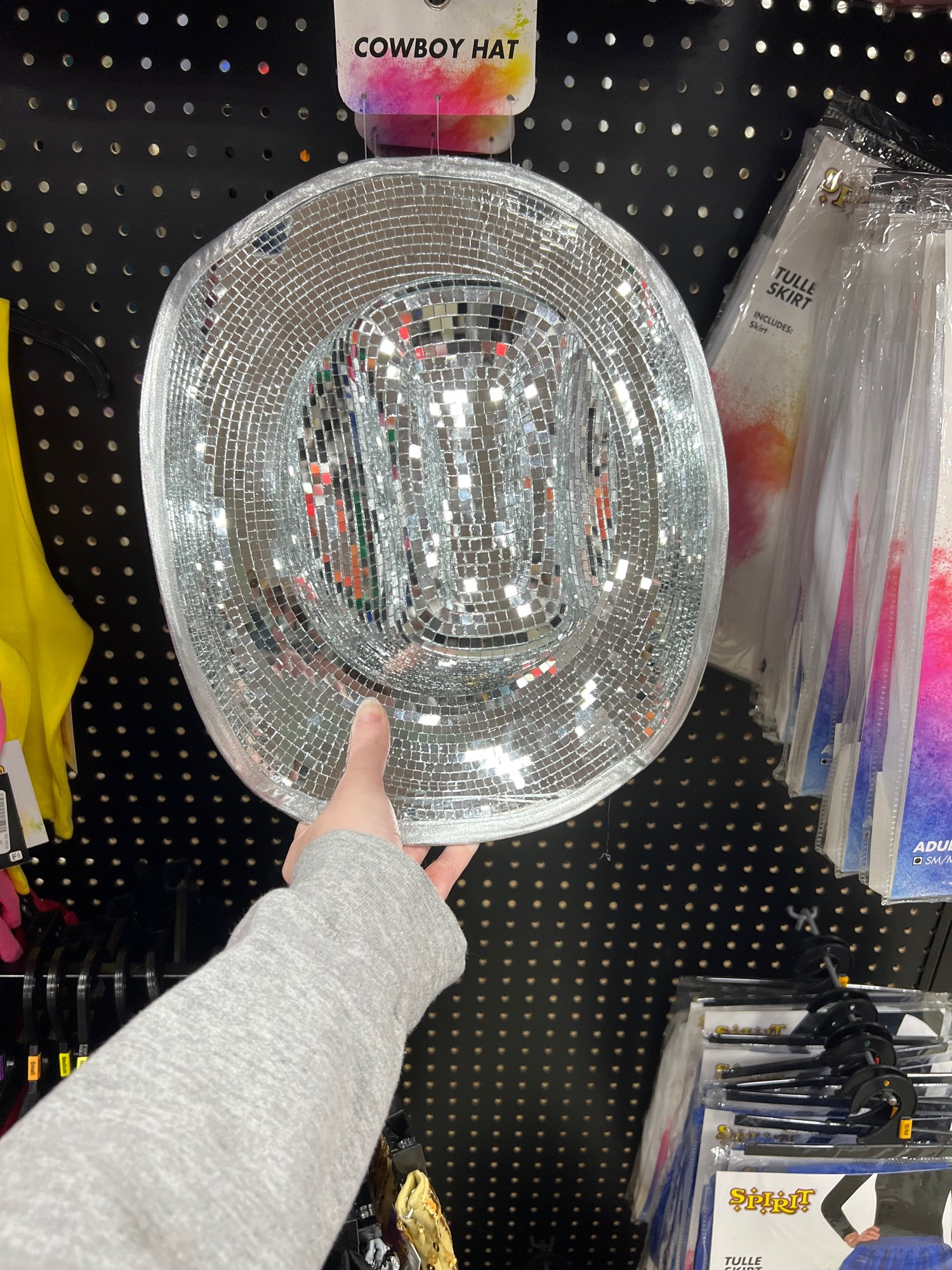 A cowboy hat made out of disco ball material.