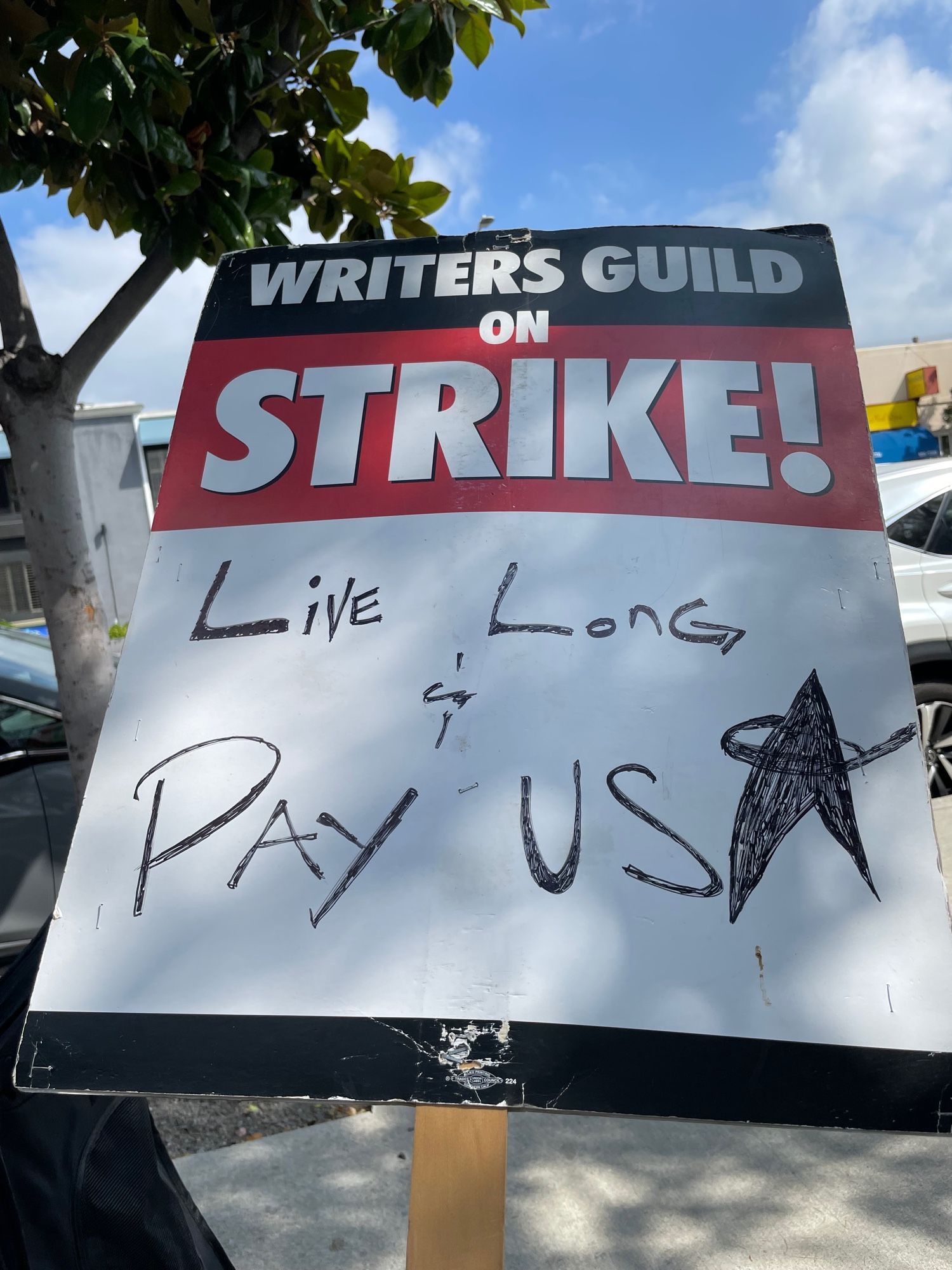 WGA strike sign reading, “Live long and pay us.”