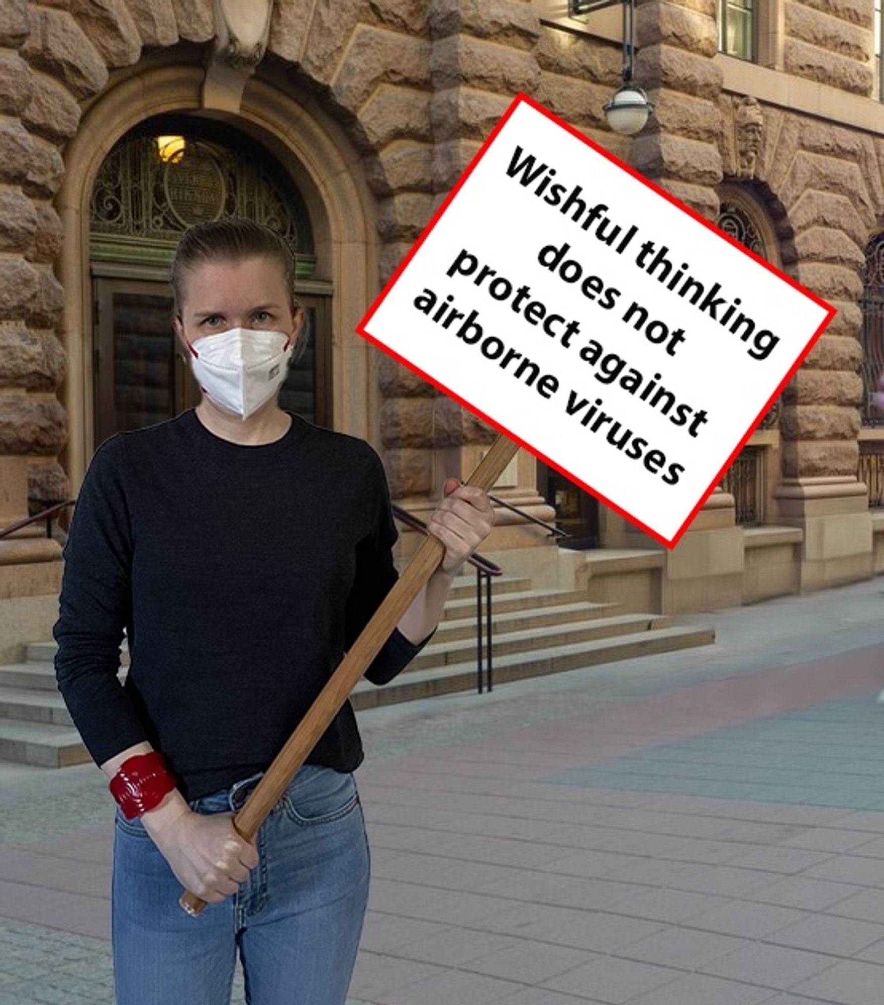 A photoshopped image of me standing outside the Swedish parliament, wearing a respirator and holding a sign saying ”Wishful thinking does not protect against airborne viruses”.