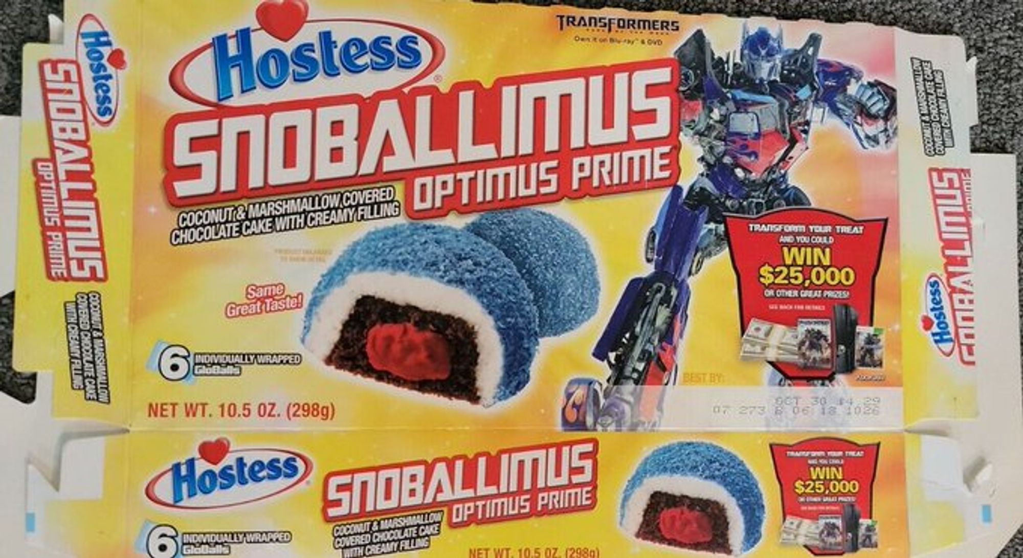 Hostess Snoballimus Prime. A chocolate snack cake, with red creme filling, covered in marshmallow and blue shredded coconut. Optimus Prime posed next to it