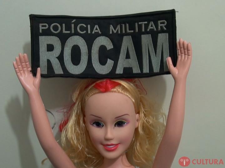 Barbie dolls in handcuffs holding signs of Brazilian police forces. DrugBust