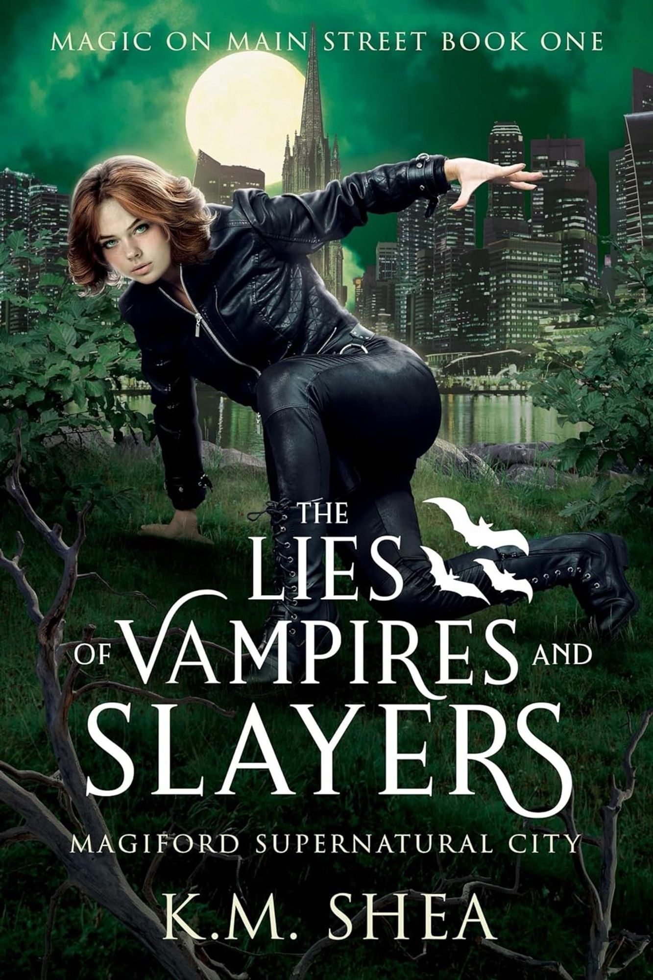 Book cover for The lies of Vampires and Slayers by KM Shea. Green with trees and grass up front and a city in the back. Woman in black crouching.