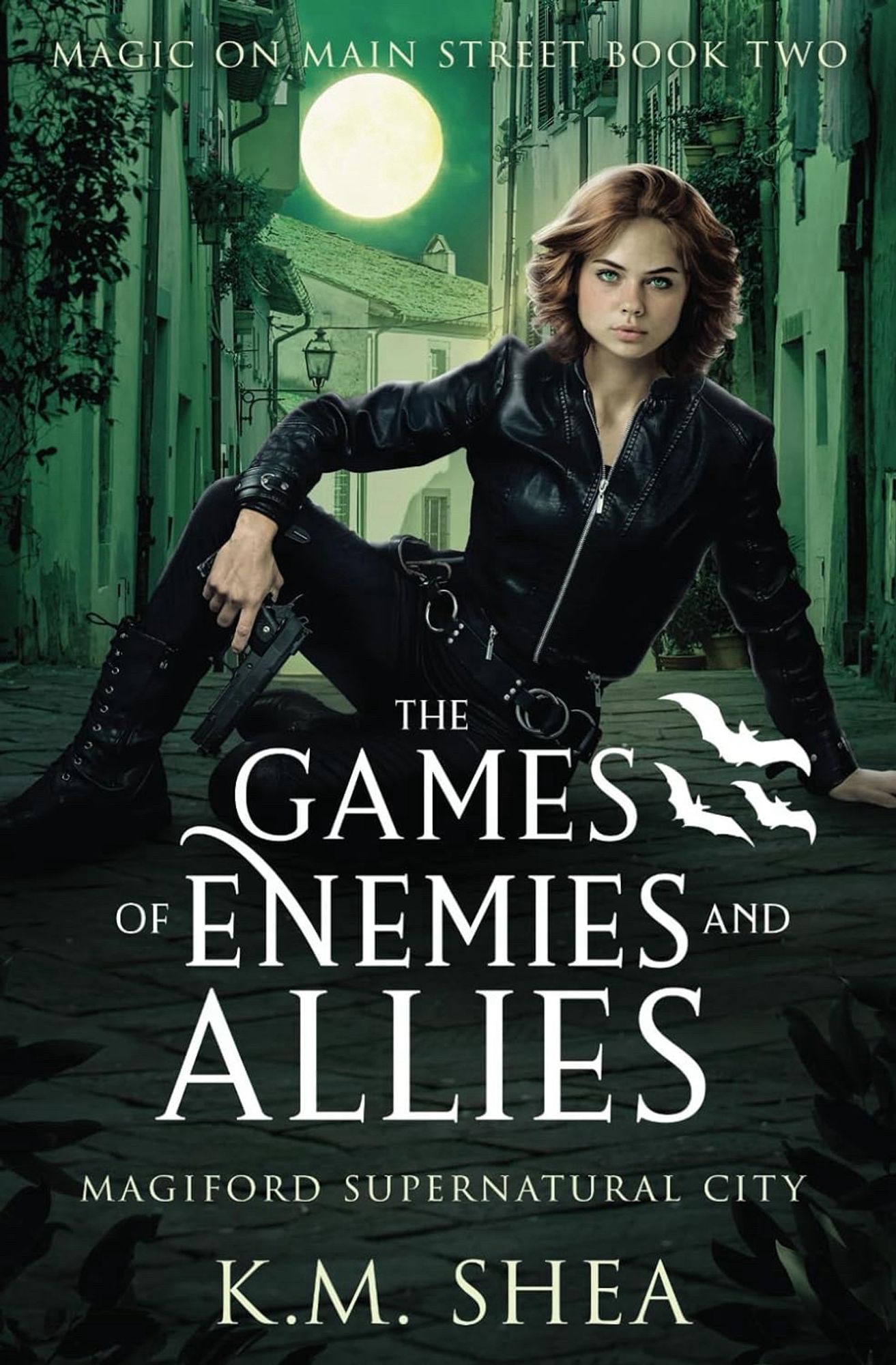 Book cover for The Games of Enemies and Allies by KM Shea. Green tinted alleyway. Woman in black sitting on ground holding a gun.